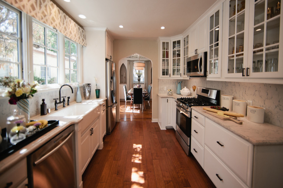 white quartz kitchen counters cabinets dark hardwood floor full height backsplash