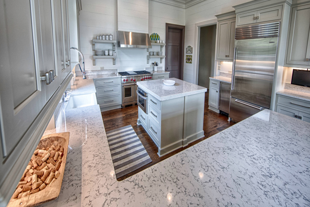 lyra quartz tops dark wood floor white cabinets tile backsplash