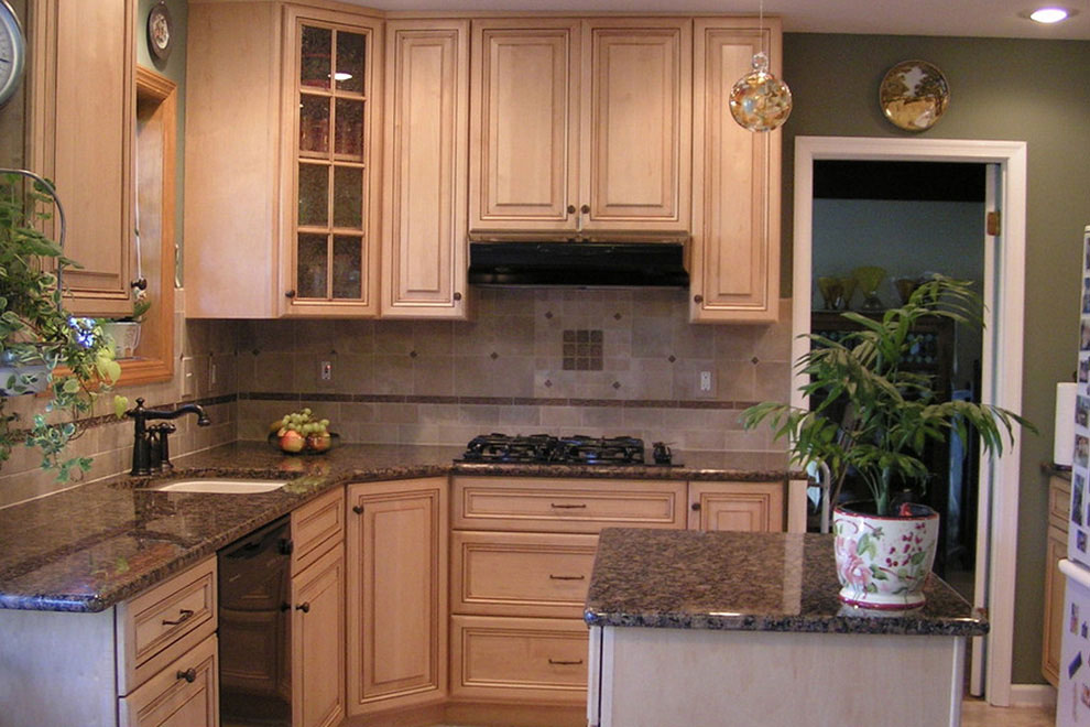 light brown kitchen cabinet with marble countertops