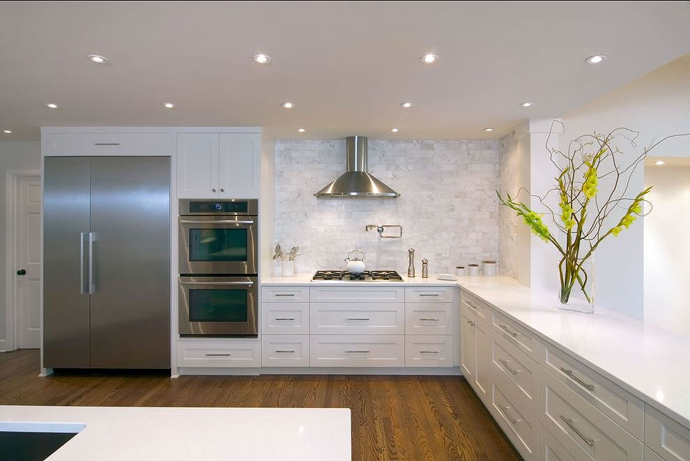 caesarstone organic white counters shaker cabinetry marble tile backsplash dark wood floor cost space free subtle room maintenance soft warm granite contrast bright lovely white base carrara counter classic natural looks like veining light love the look gray grey stone