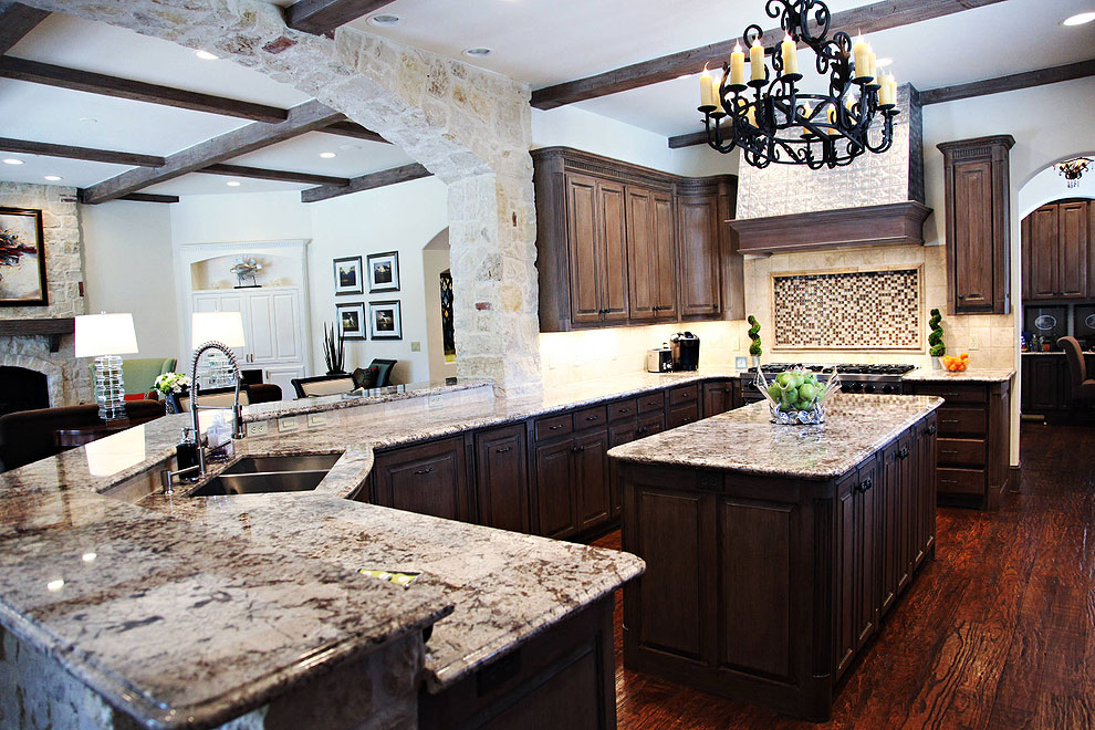 crema delicatus granite counters dark cabinets wood floor cream travertine tile backsplash
