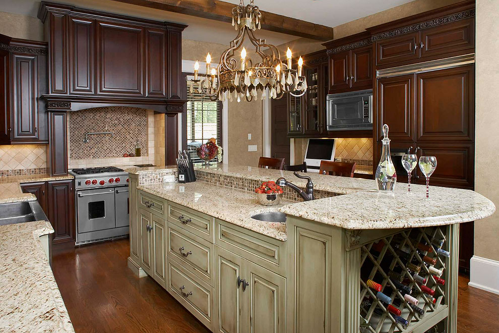 giallo ornamental granite counter tops dark cabinets green island cabinet dark wood floor travertine tile backsplash