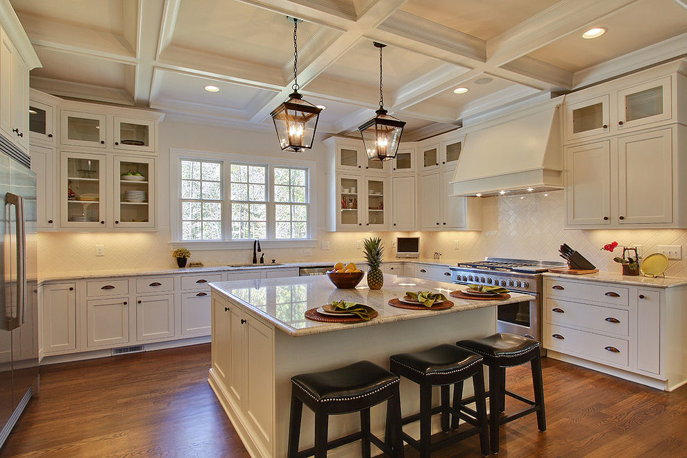 white cabinets pendant lights coffered ceilings cream countertops