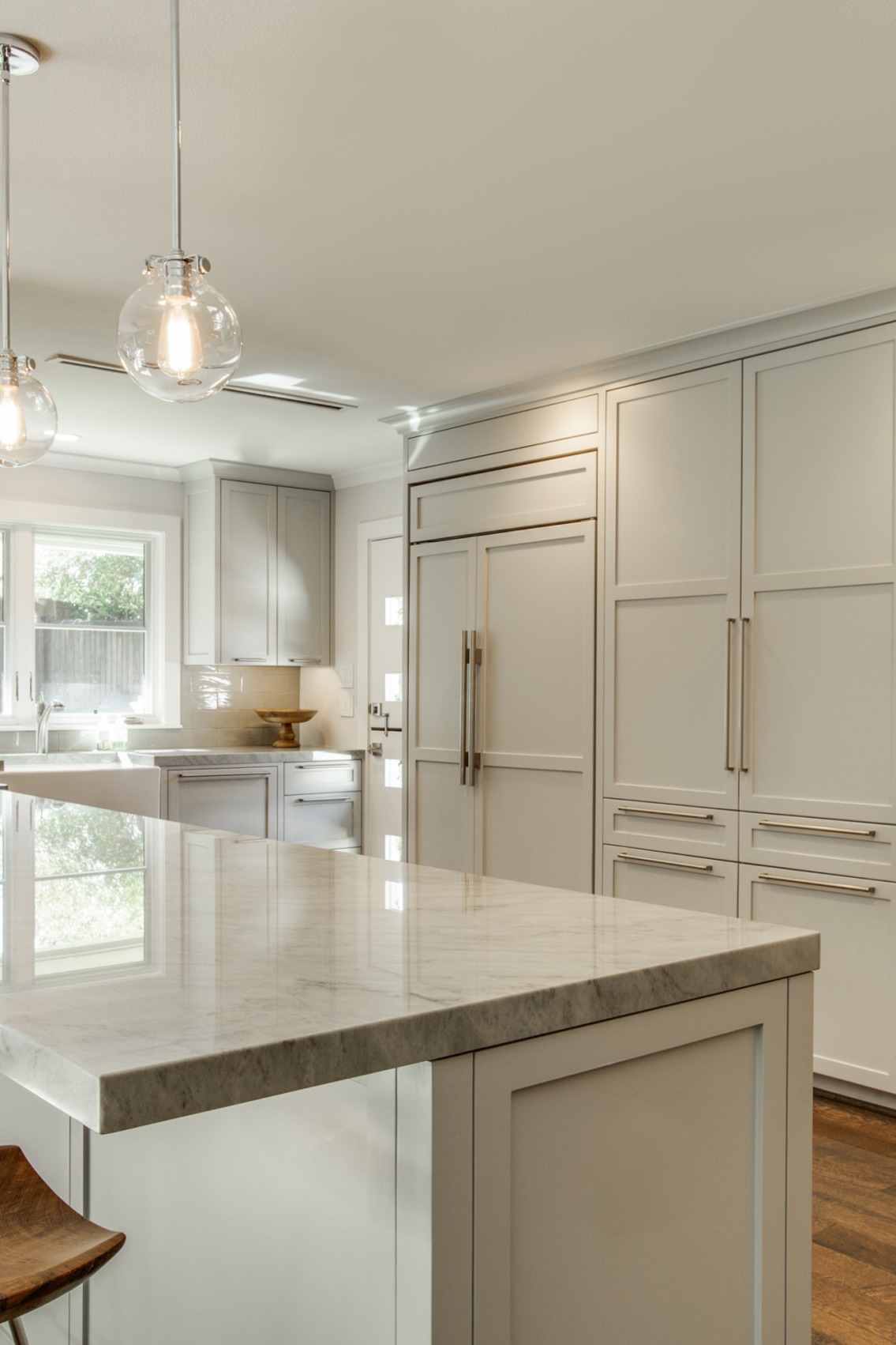 Sea Pearl Quartzite Kitchen Countertops Light Gray Cabinets White Backsplash Dark Hardwood Floor
