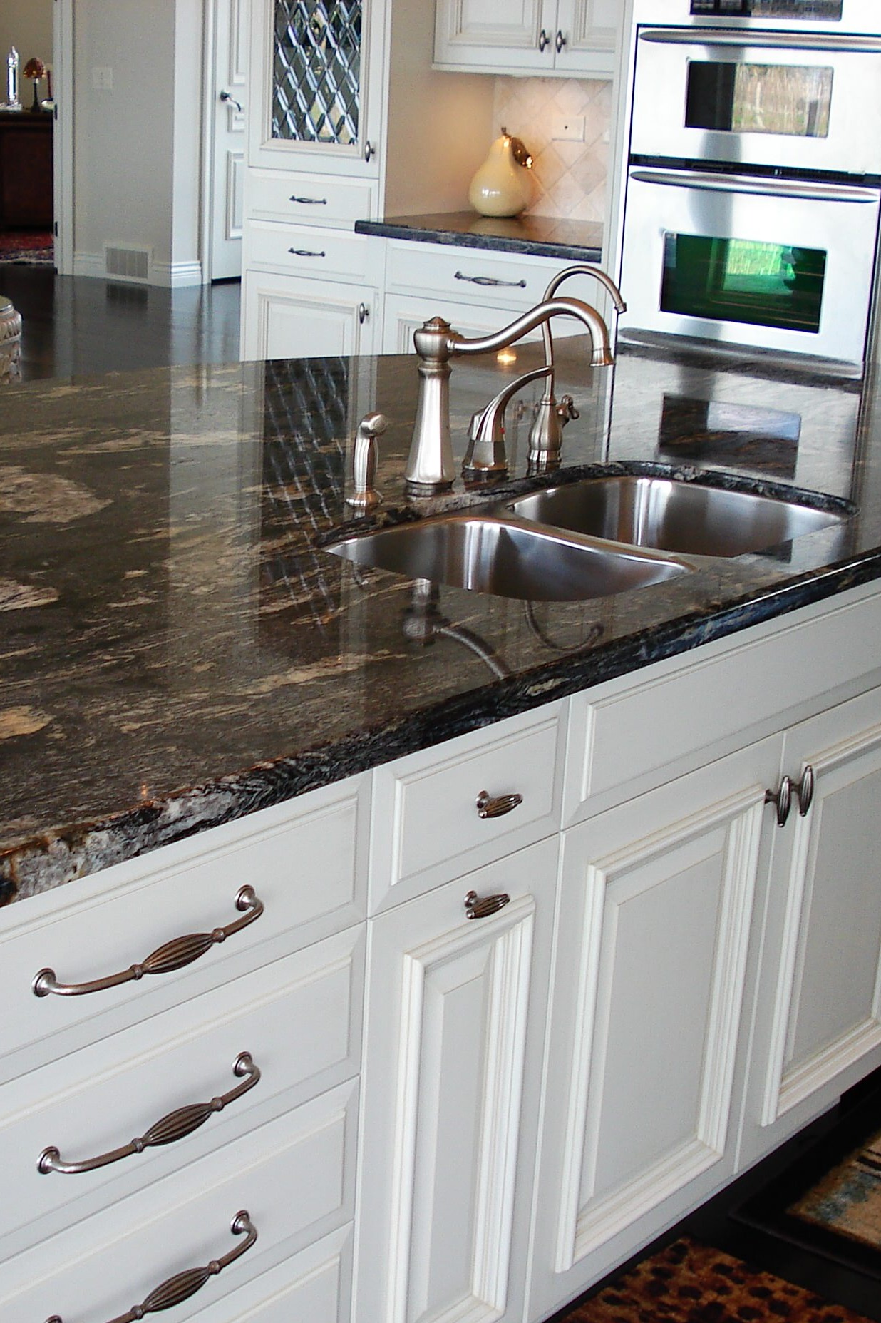 Titanium Granite Countertop White Cabinet Cream Backsplash Tile Dark Hardwood Floor 1