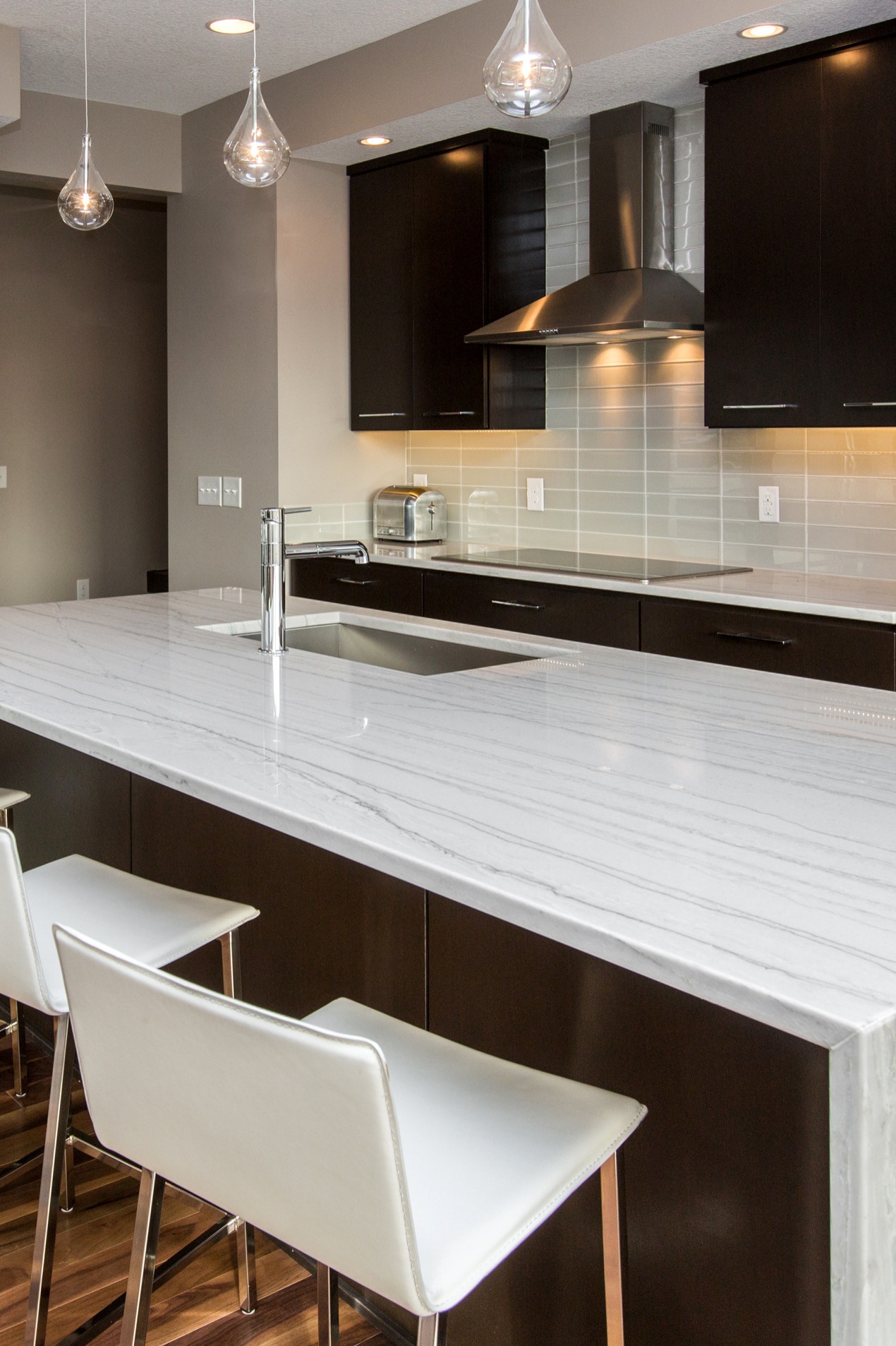 White Macaubas Quartzite Countertops Espresso Dark Cabinets Subway Style Backsplash Tiles Hardwood Floor
