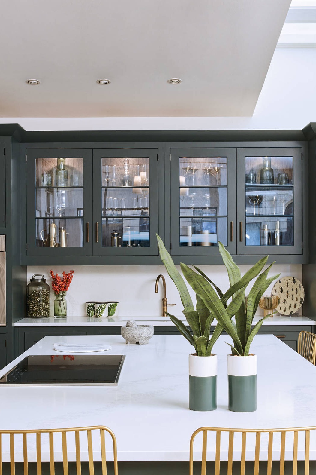White Quartz Countertops Dark Green Kitchen Cabinets Subway Tile Backsplash Hardwood Floor