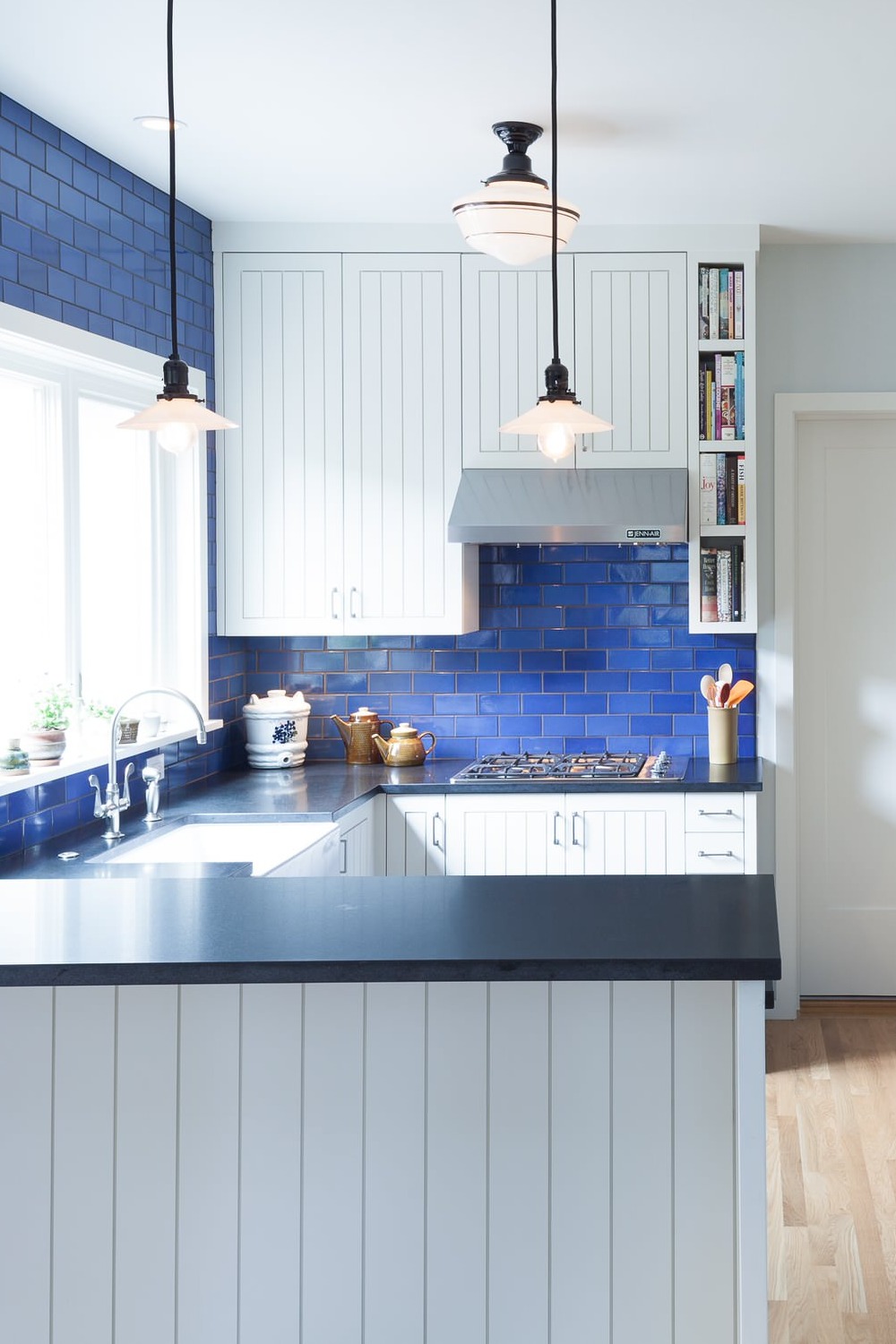 Black Honed Granite Countertop White Cabinet Blue Subway Tile Backsplash Light Wood Floor