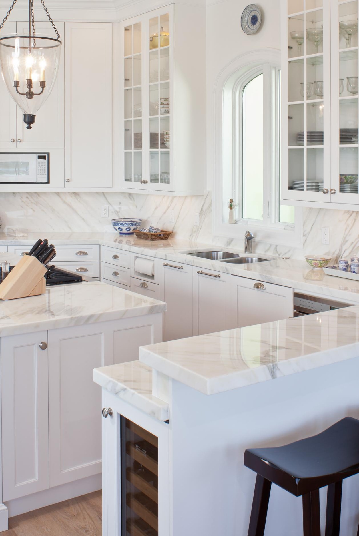 Calacatta Gold Marble Countertops Backsplash White Cabinets Light Hardwood Floor