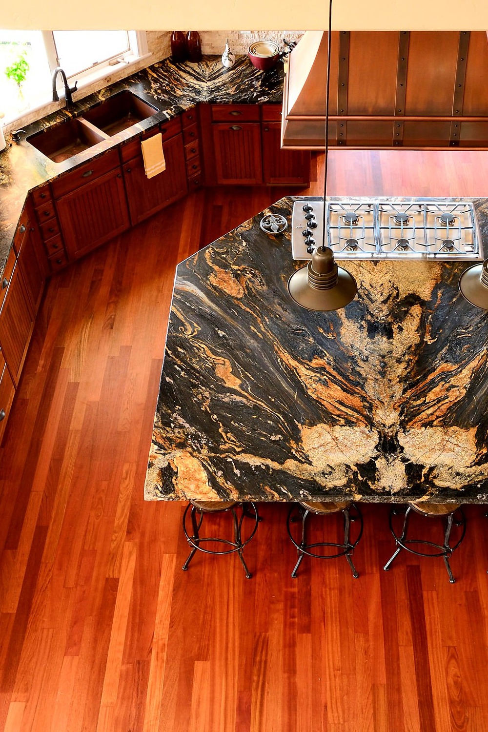 Magma Gold Granite Countertop Dark Wood Flooring Cream Stone Backsplash Brown Cabinet