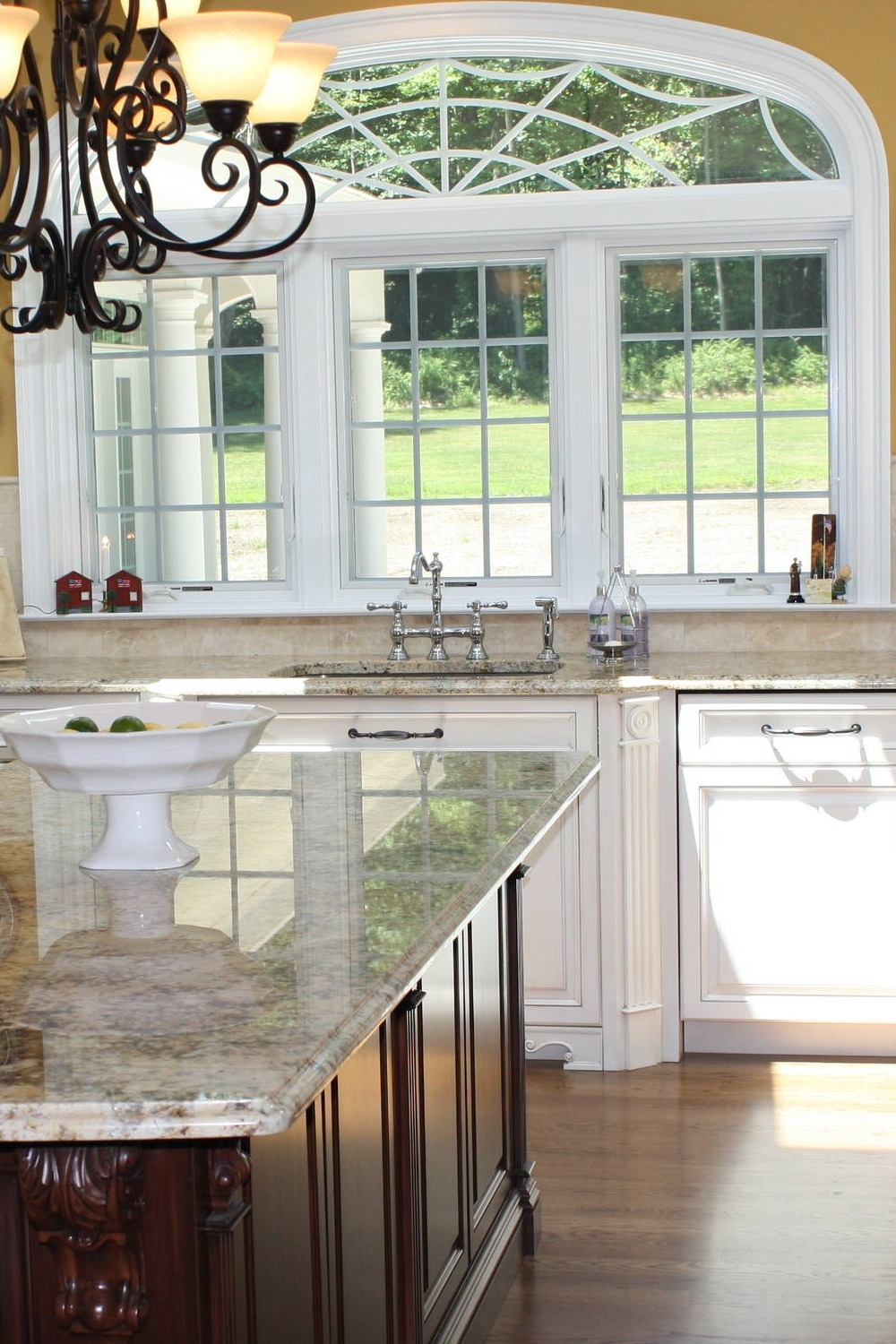 White Kitchen Cabinets Cream Travertine Backsplash Solarius Granite Countertops Dark Floors 1