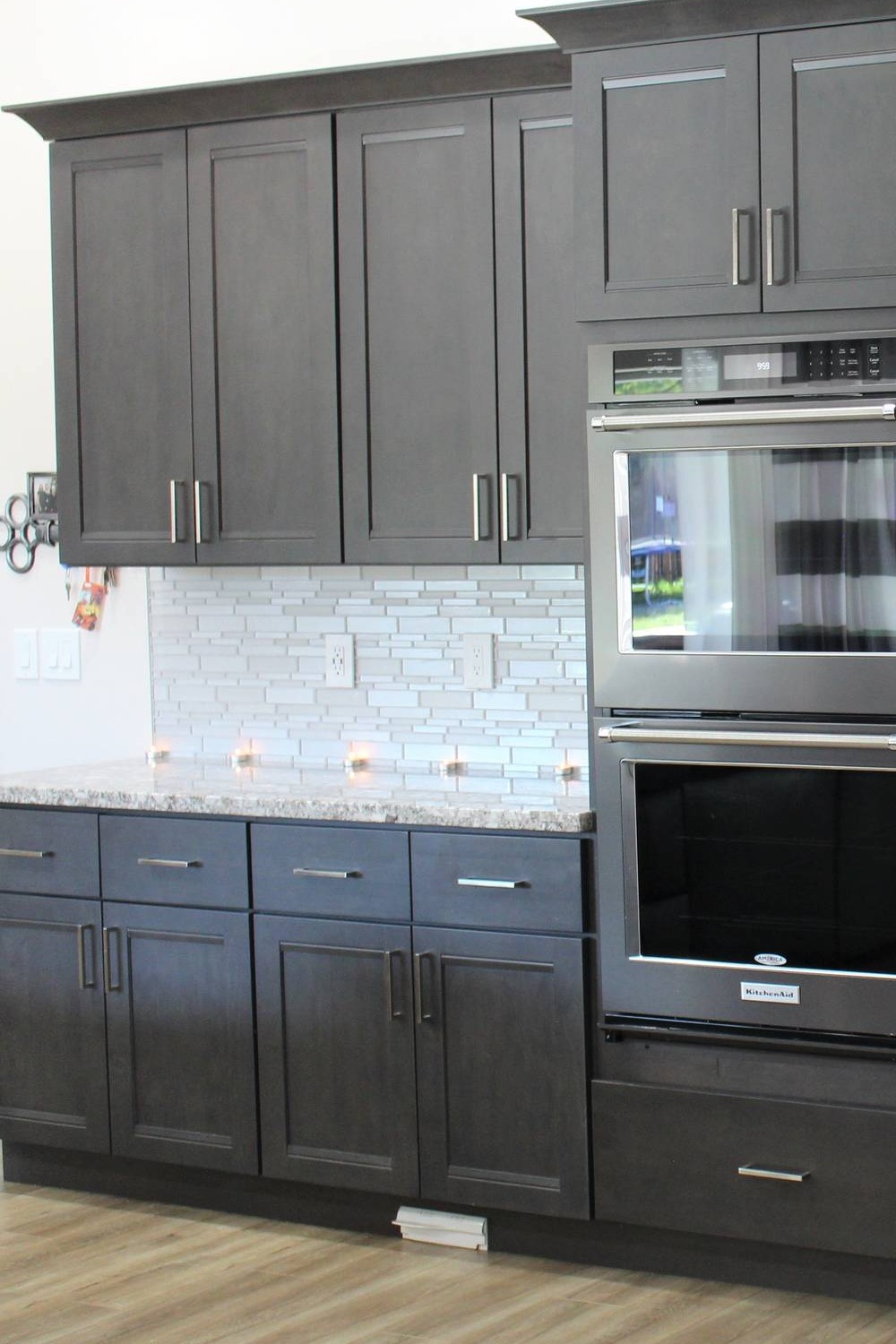 Dark Gray Shaker Cabinets Glass Tile Backsplash Granite Countertops Light Wood Floor