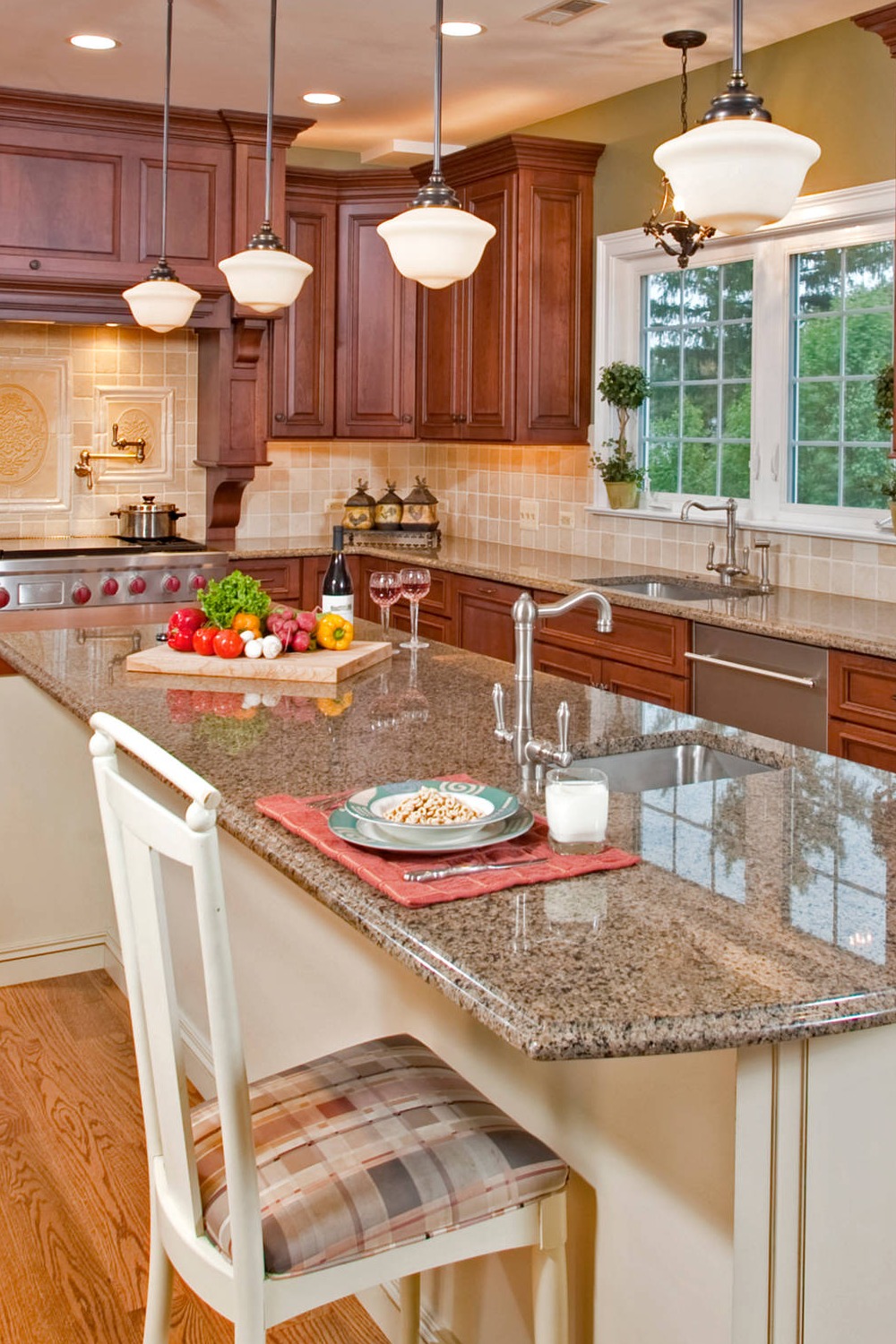 Brown Granite Counters Travertine Tile Backsplash Cherry Wood Cabinet Dark Hardwood Floor