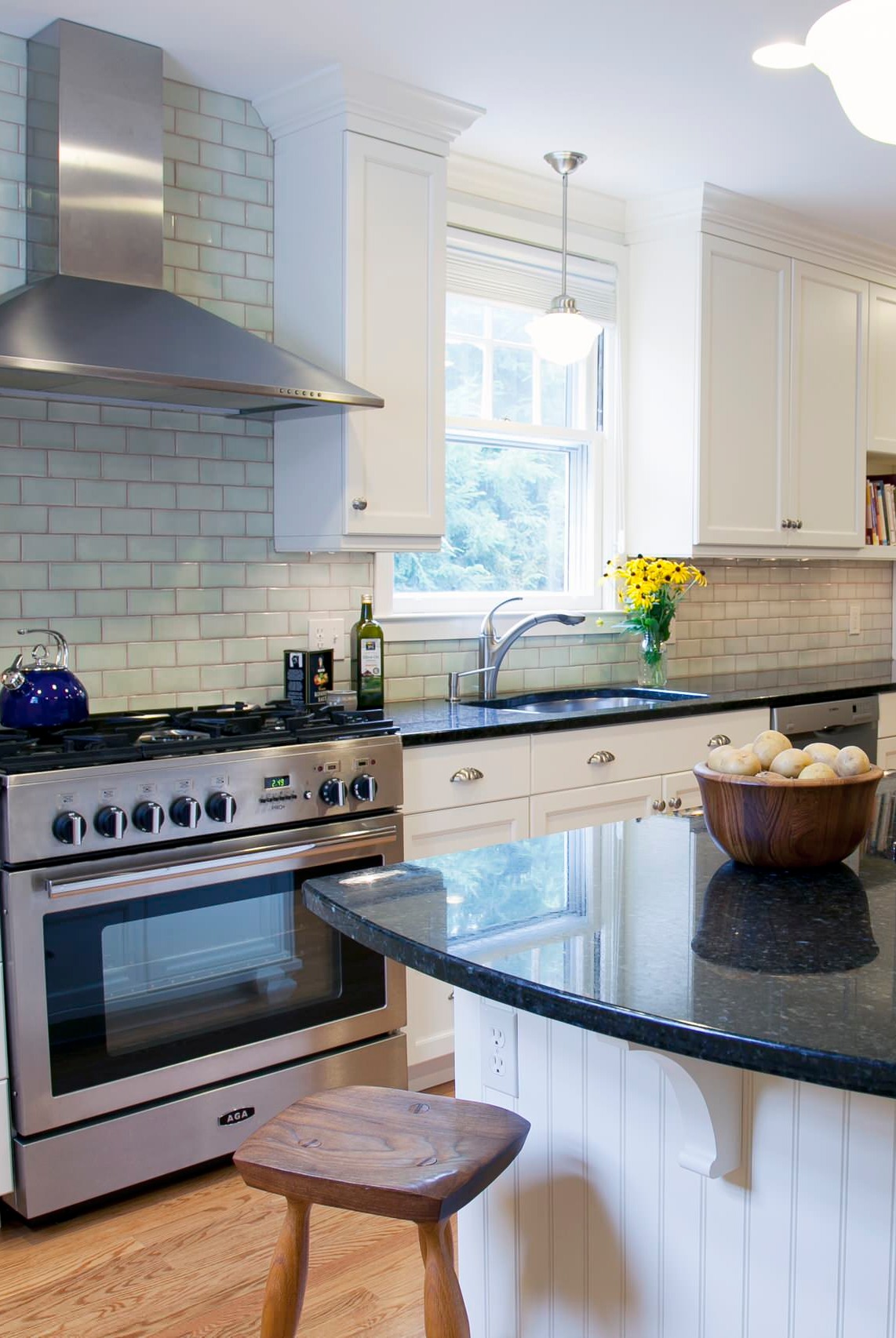 Cream Glossy Subway Style Backpslash White Cabinets Black Granite Countertops Natural Hardwood Floor