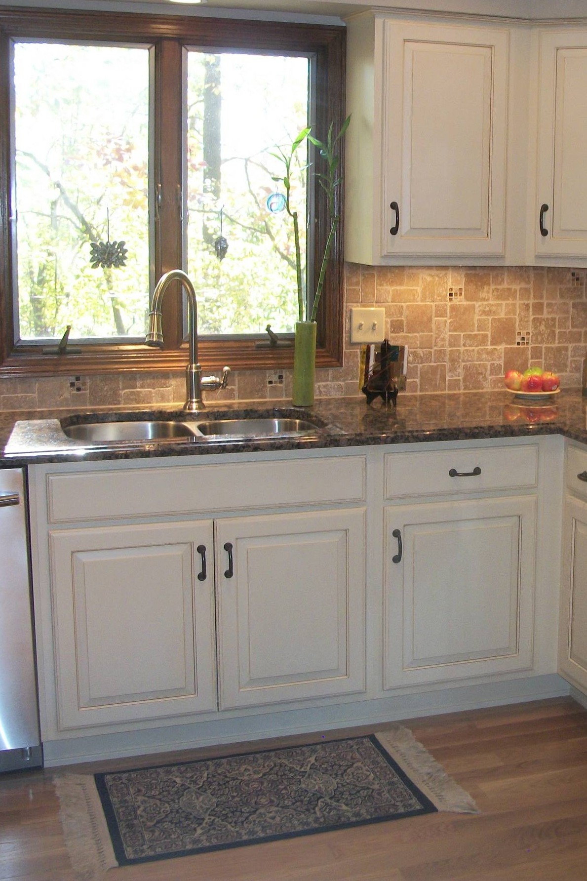 White Cabinets Brown Multi Sized Travertine Backsplash Tiles Brown Granite Countertops Hardwood Floor