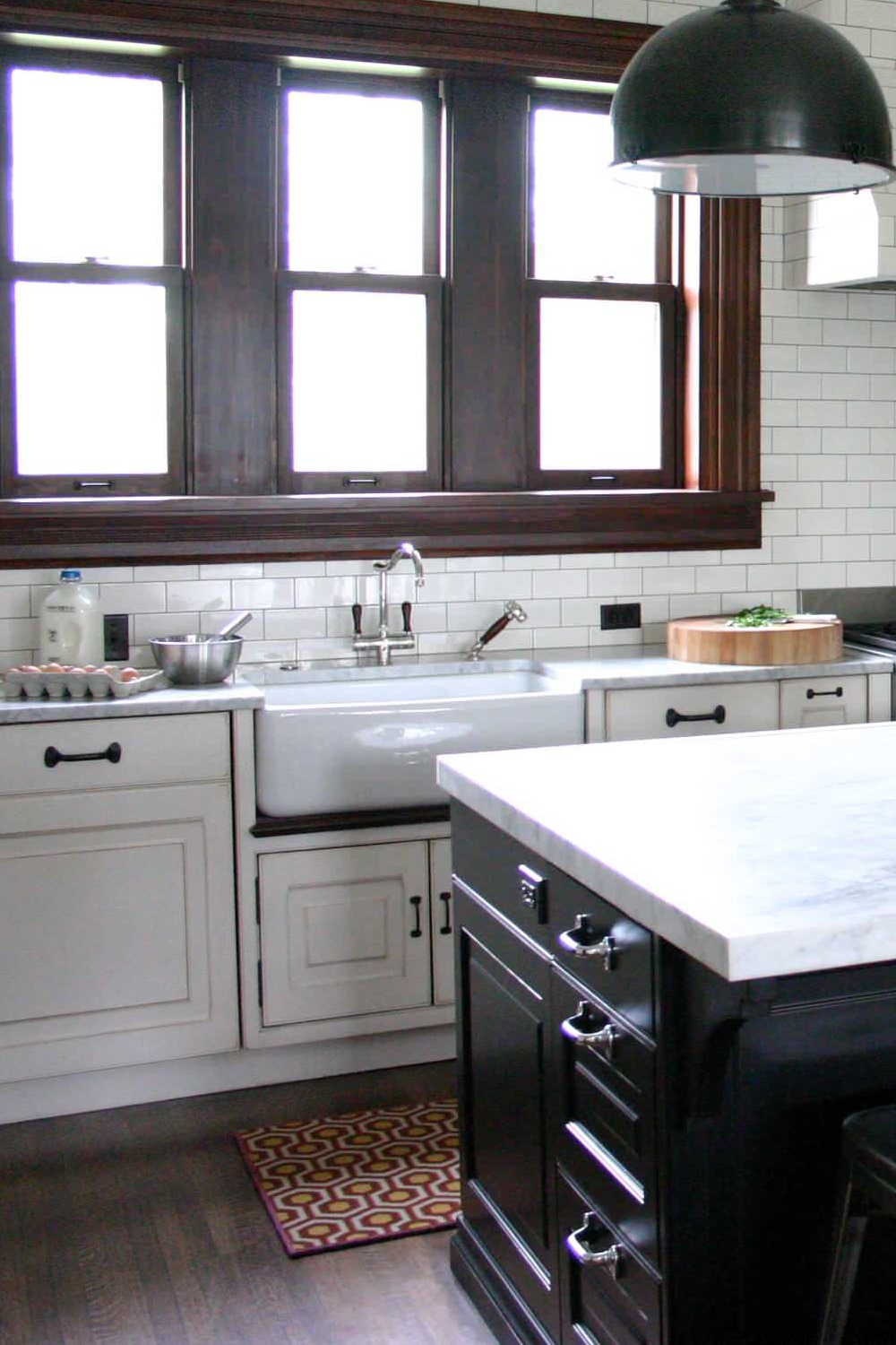 White Marble Countertops Black Island White Kitchen Cabinets Dark Hardwood Floor Subway Backsplash