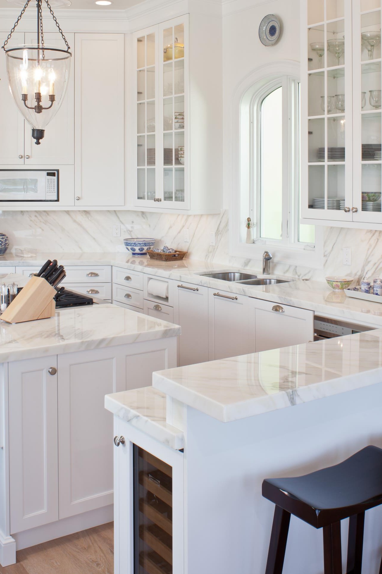 White Marble Countertops Full Height Backsplash Cabinets Dark Hardwood Floor