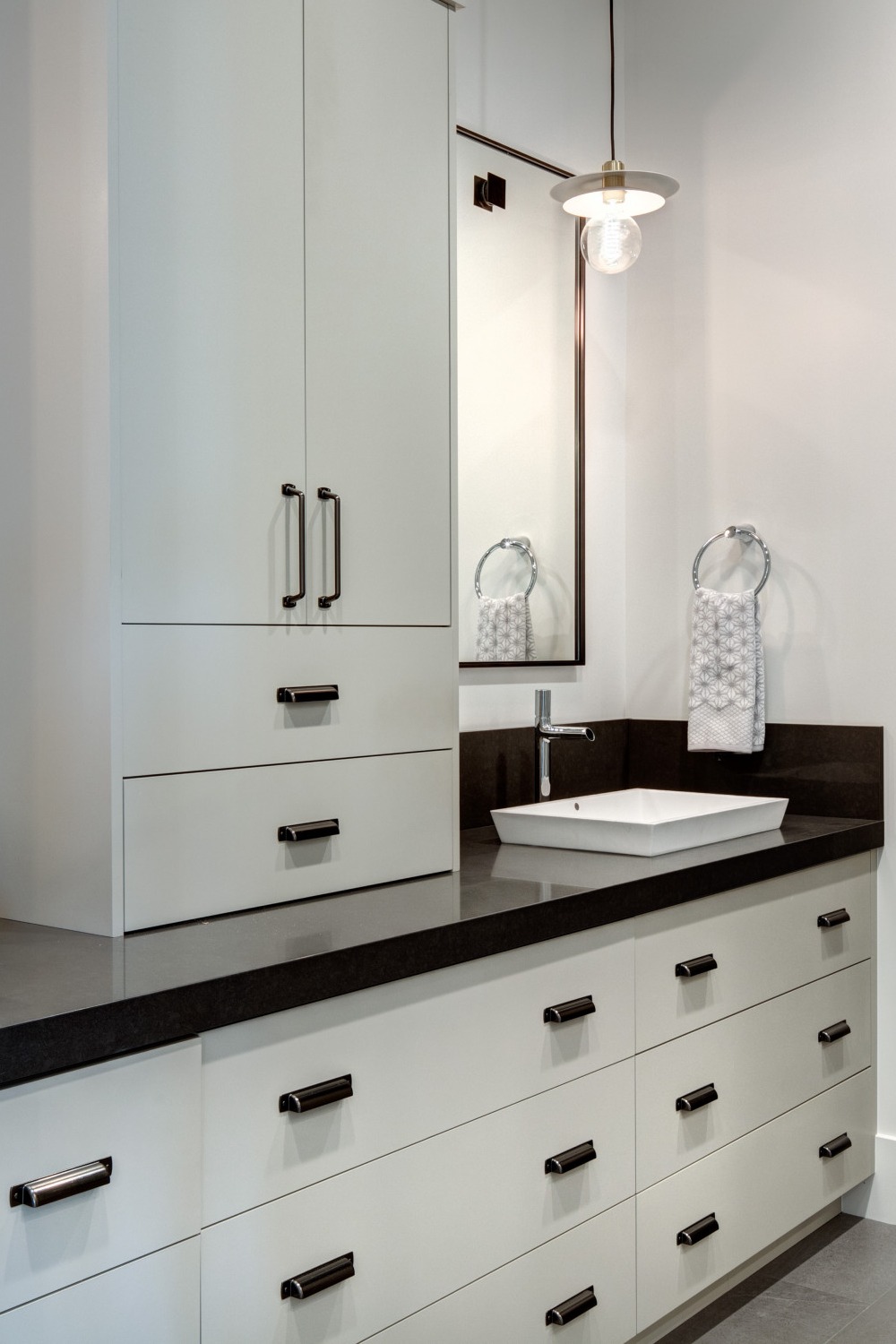 Black Quartz Countertops Backsplash Flat Panel White Cabinets Gray Porcelain Floor Tile
