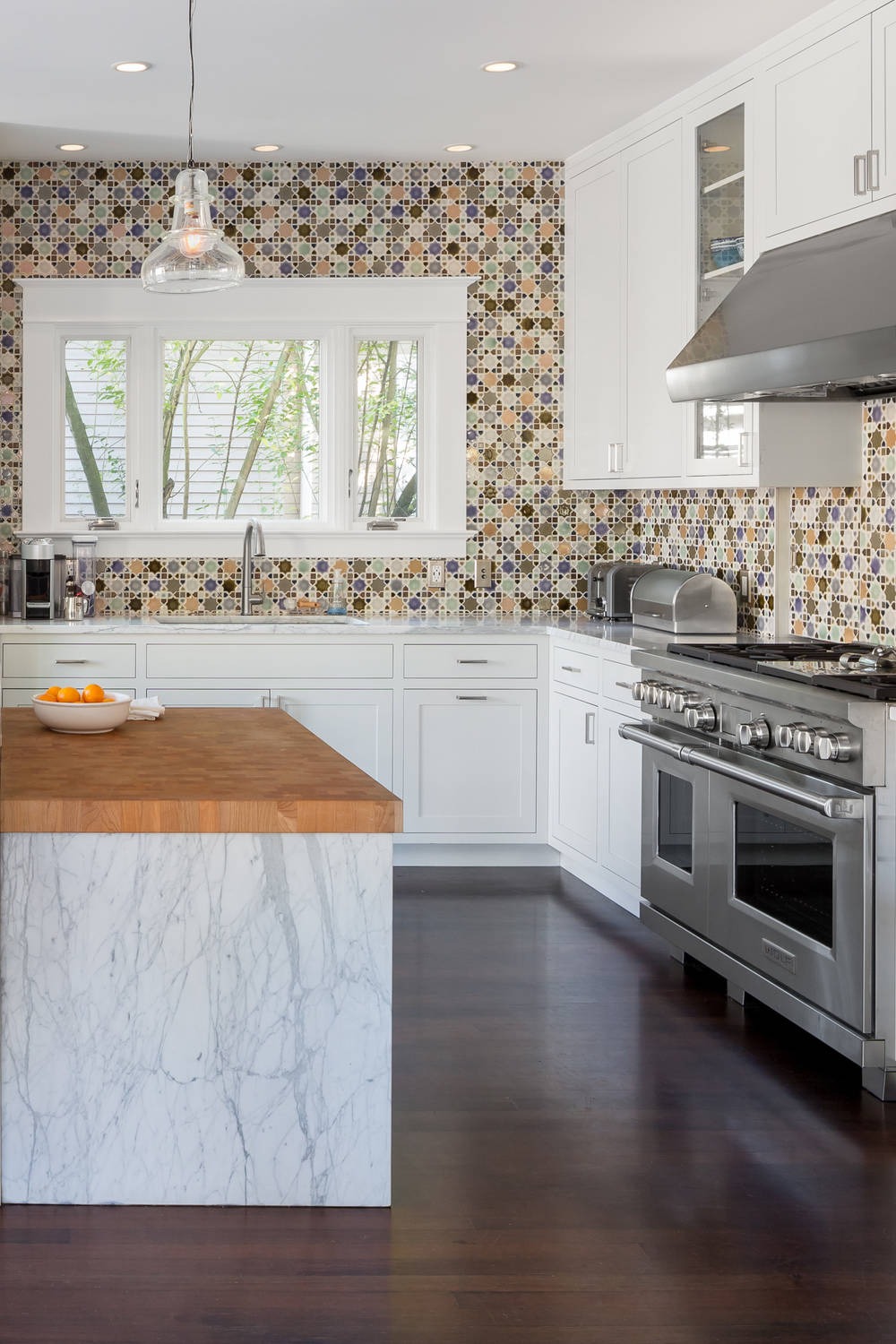 Dark Wood Floor Multicolored Mosaic Tile Backsplash Shaker White Cabinets Marble Countertops