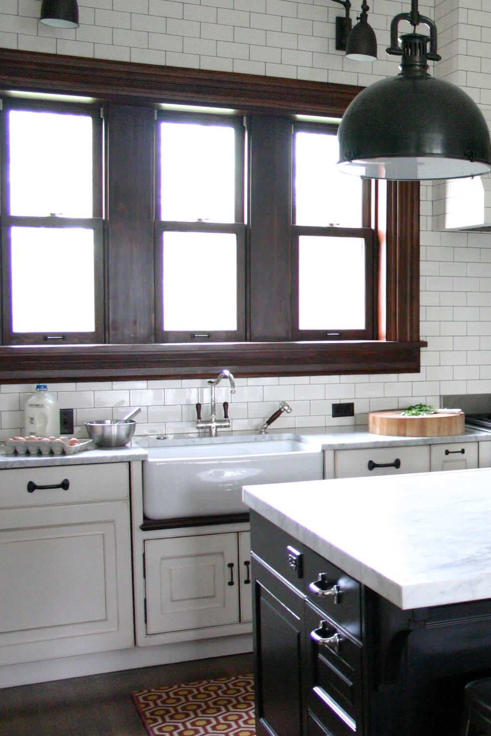 Glass Front White Cabinets Marble Countertops Subway Tile Backsplash Farmhouse Sink Dark Wood Floor