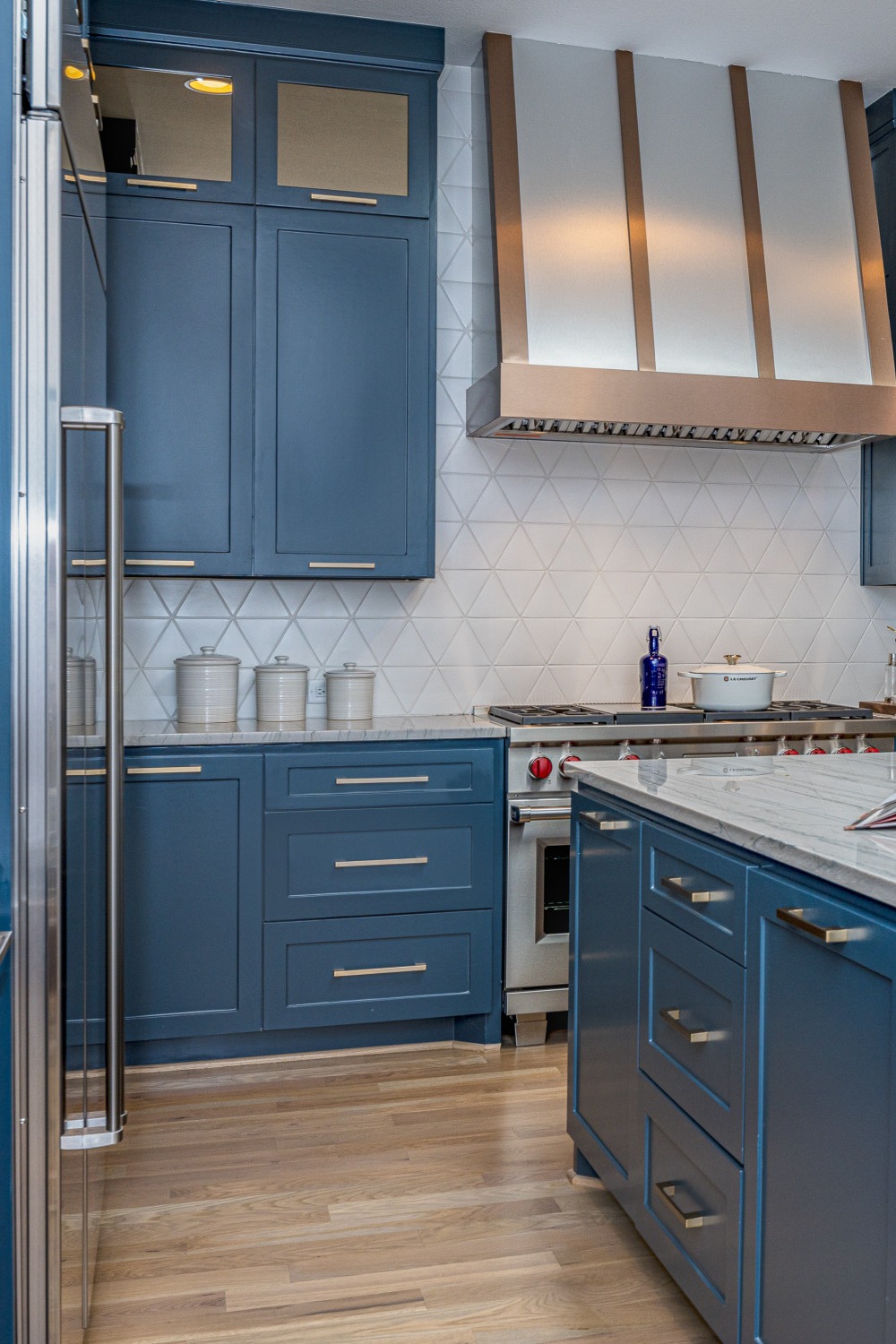 Glossy Blue Cabinetry White Countertops Backsplash Tile Medium Dark Wood Floor