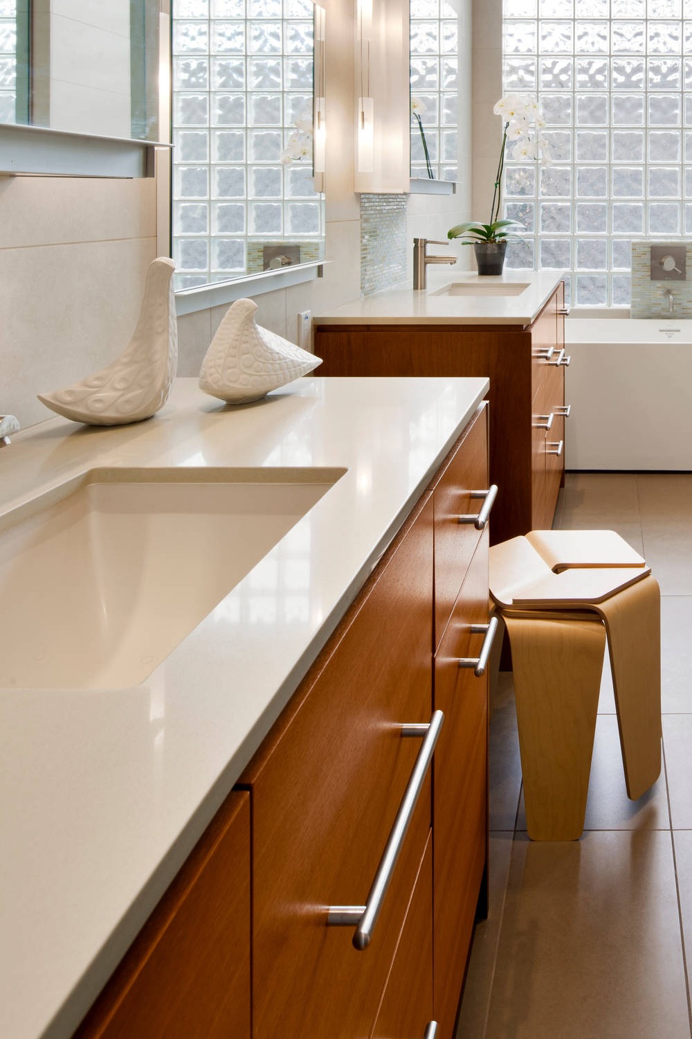 White Quartz Countertops Beige Porcelain Floor Tiles Flat Panel Medium Tone Wood Cabinets Cream Backsplash