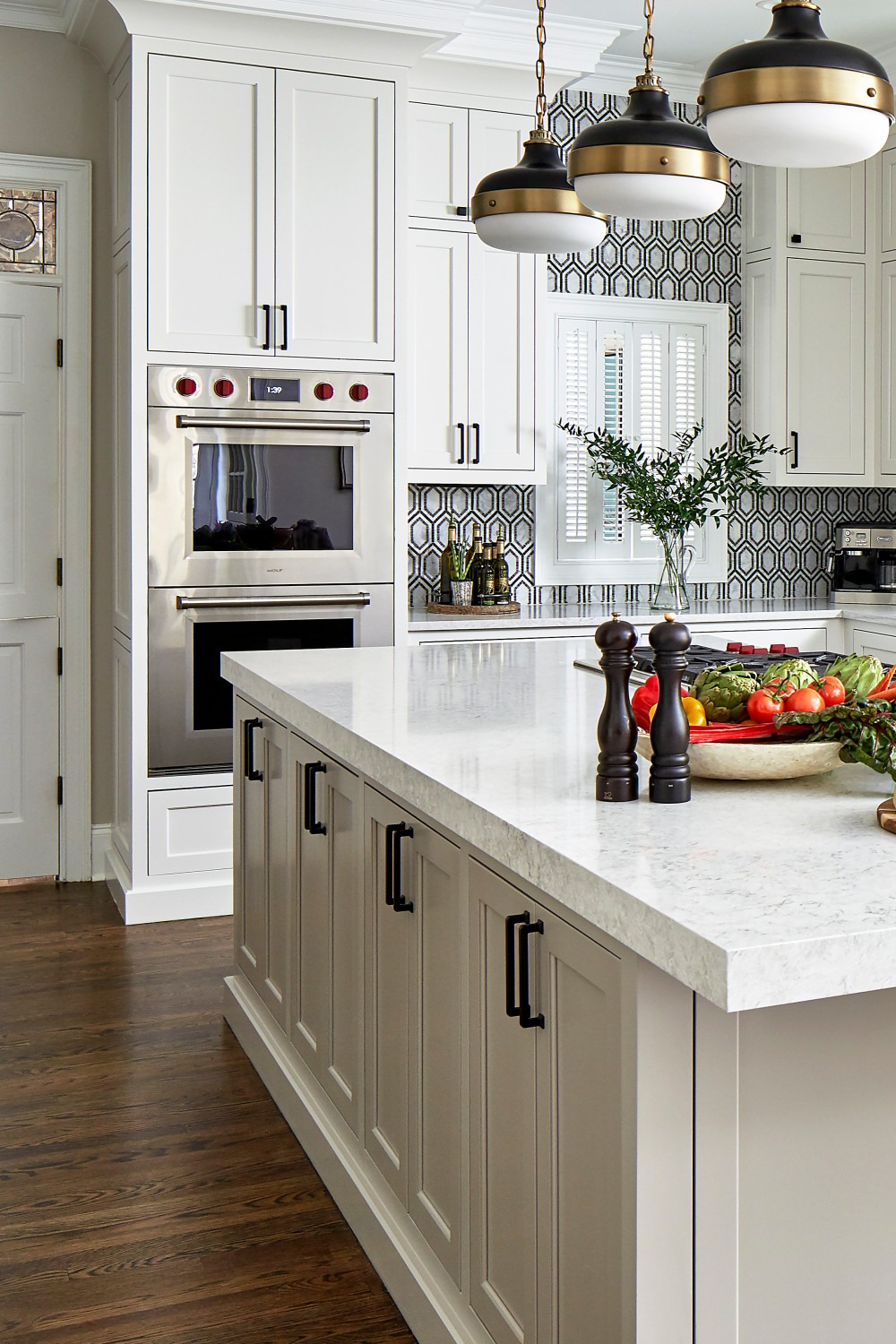 White Shaker Cabinetry Quartz Counters Multi Color Tile Backsplash Dark Hardwood Flooring