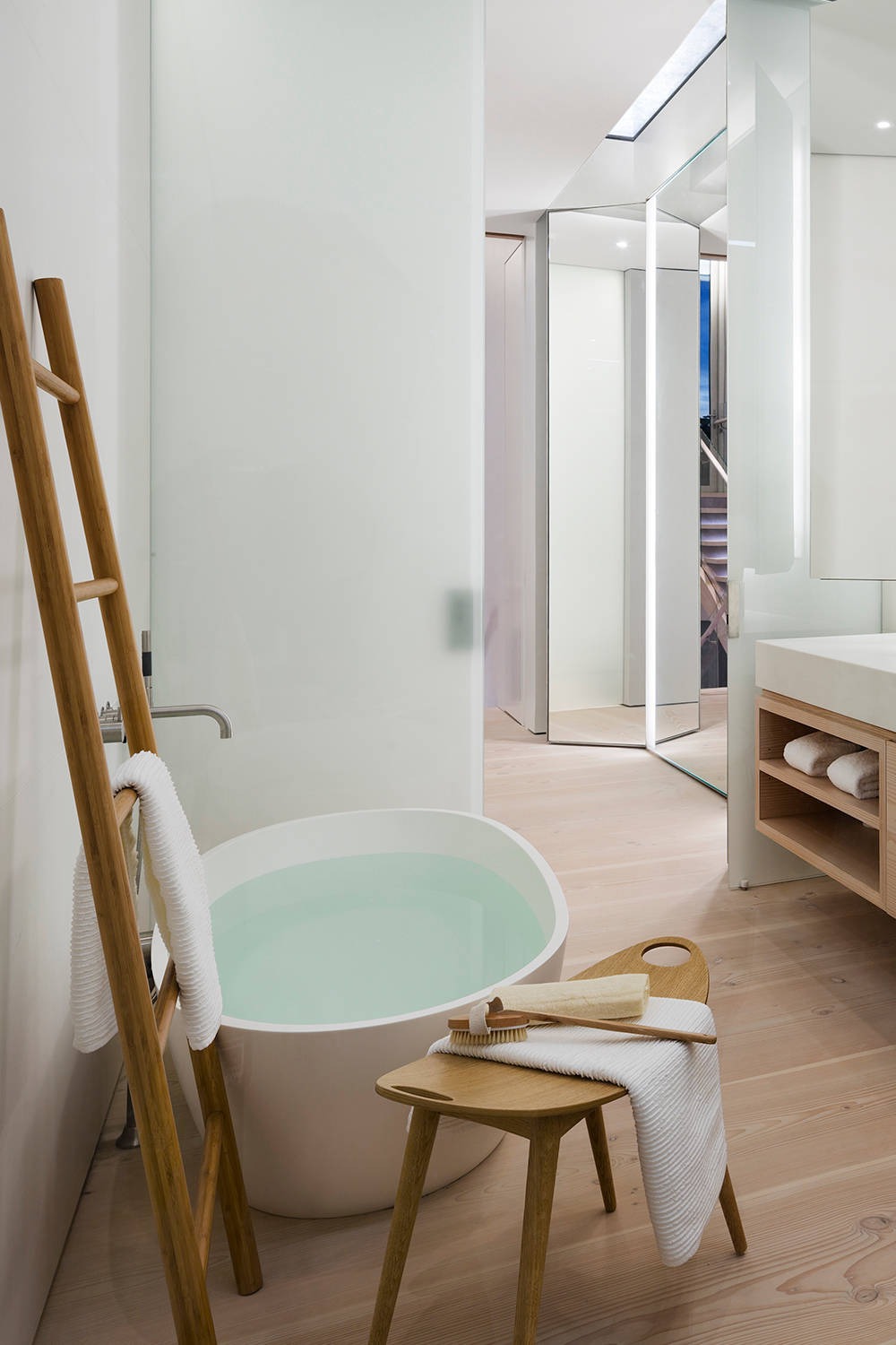 Light Wood Floor Flat Panel Cabinets White Countertops Free Standing Bathtub Towel Rack