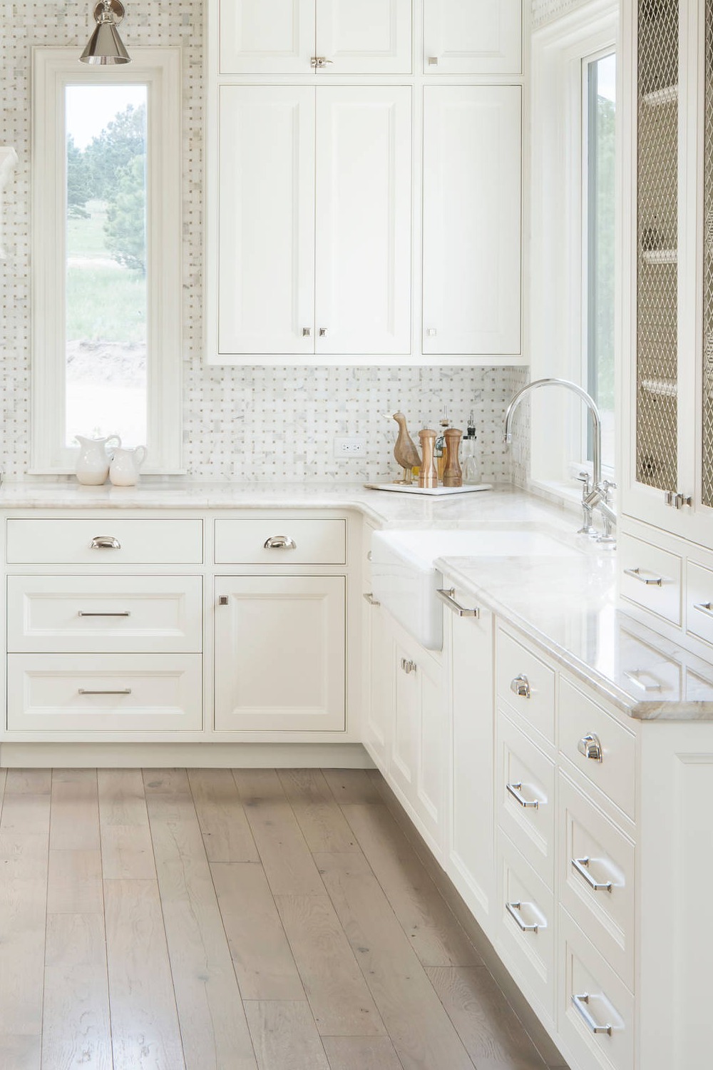 White Mosaic Tile Backsplash Cabinets Beige Countertops Light Wood Floor Farmhouse Sink