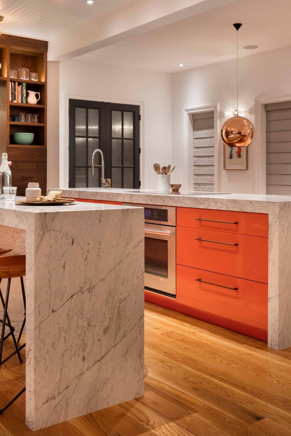 Flat Panel Orange Cabinets Marble Counters Medium Tone Wood Flooring Miter Edge Islands