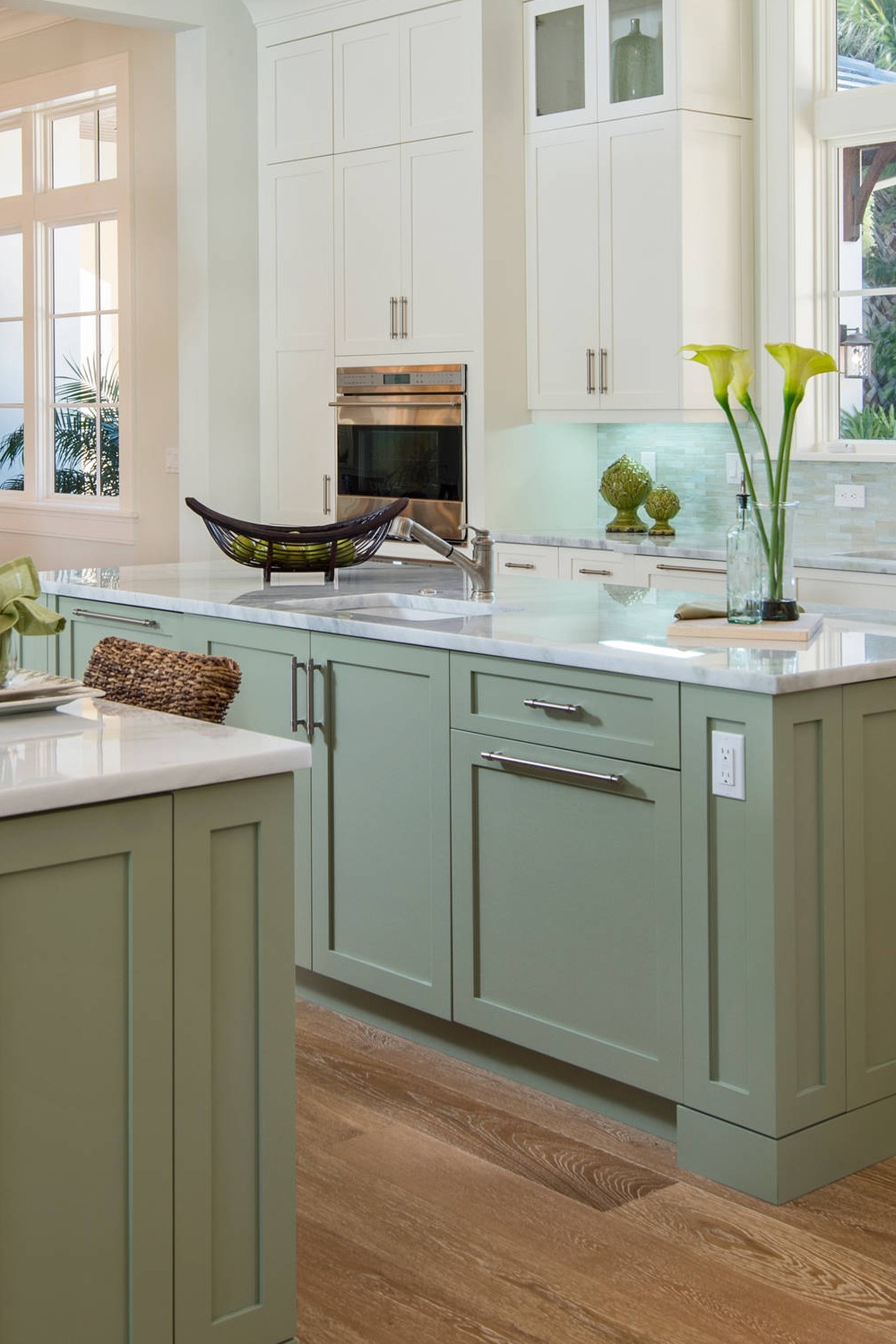 Green Cabinetry Grey Glass Tile Backsplash Light Wood Flooring Marble Counters