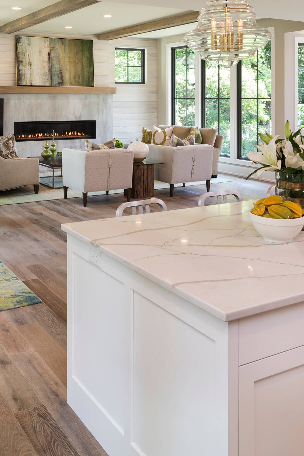 Light Wood Floor Shaker White Cabinets Quartz Countertops Open Concept Kitchen Layout Pendant Lighting