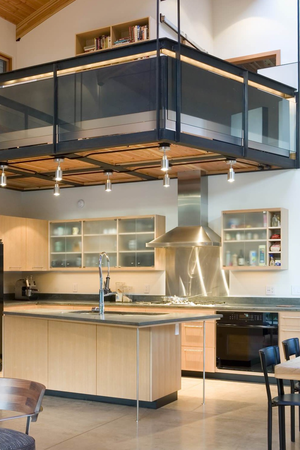 Open Concept Kitchen Design Glass Front Light Wood Cabinets Concrete Countertops Cream Floor Tiles Metal Backsplash