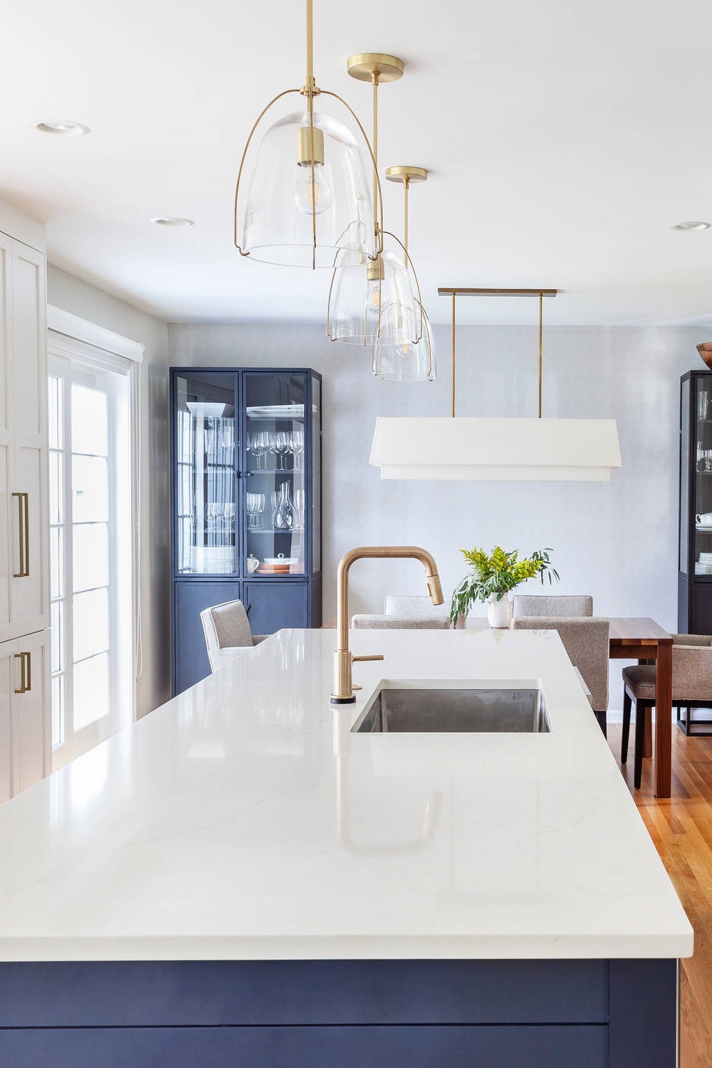 Pendant Lighting Blue Cabinets White Quartz Countertops Wood Floor Gray Walls