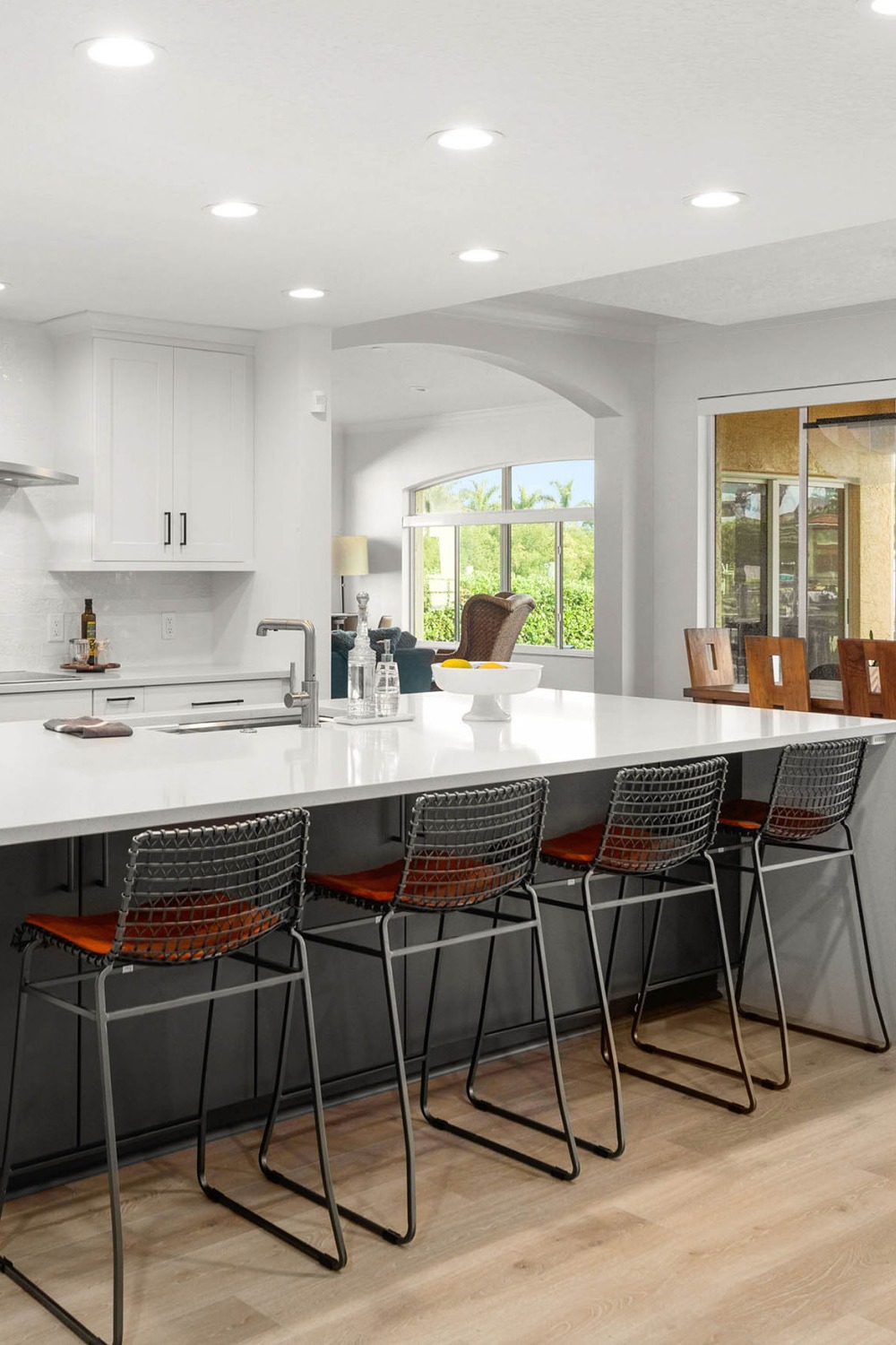 Contemporary Coast Kitchen Grey Island White Kitchen Cabinetry Quartz Counters Laminate Floor Ceramic Backsplash