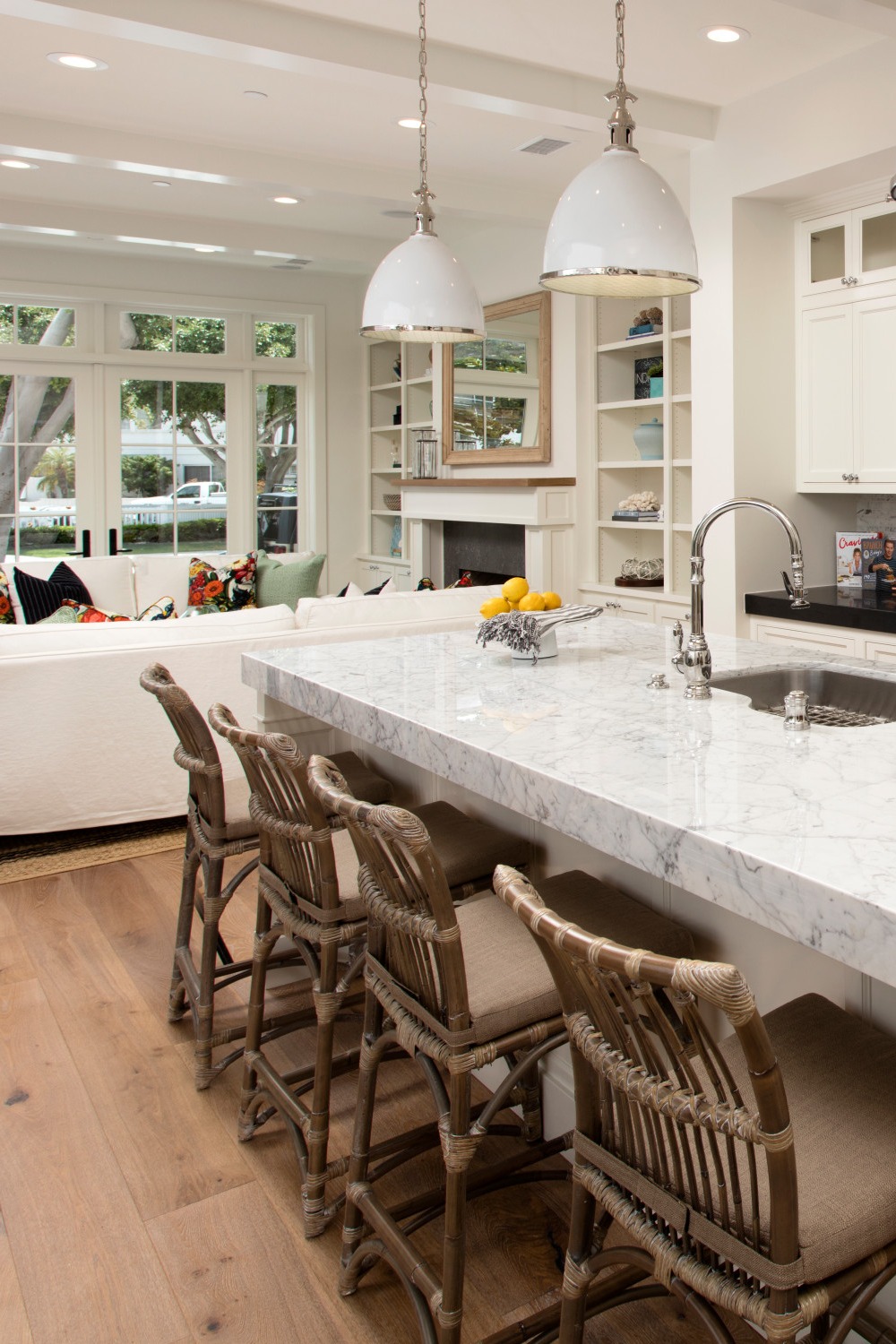 Medium Tone Hardwood Open Concept Kitchen Marble Countertops Backsplash White Cabinetry