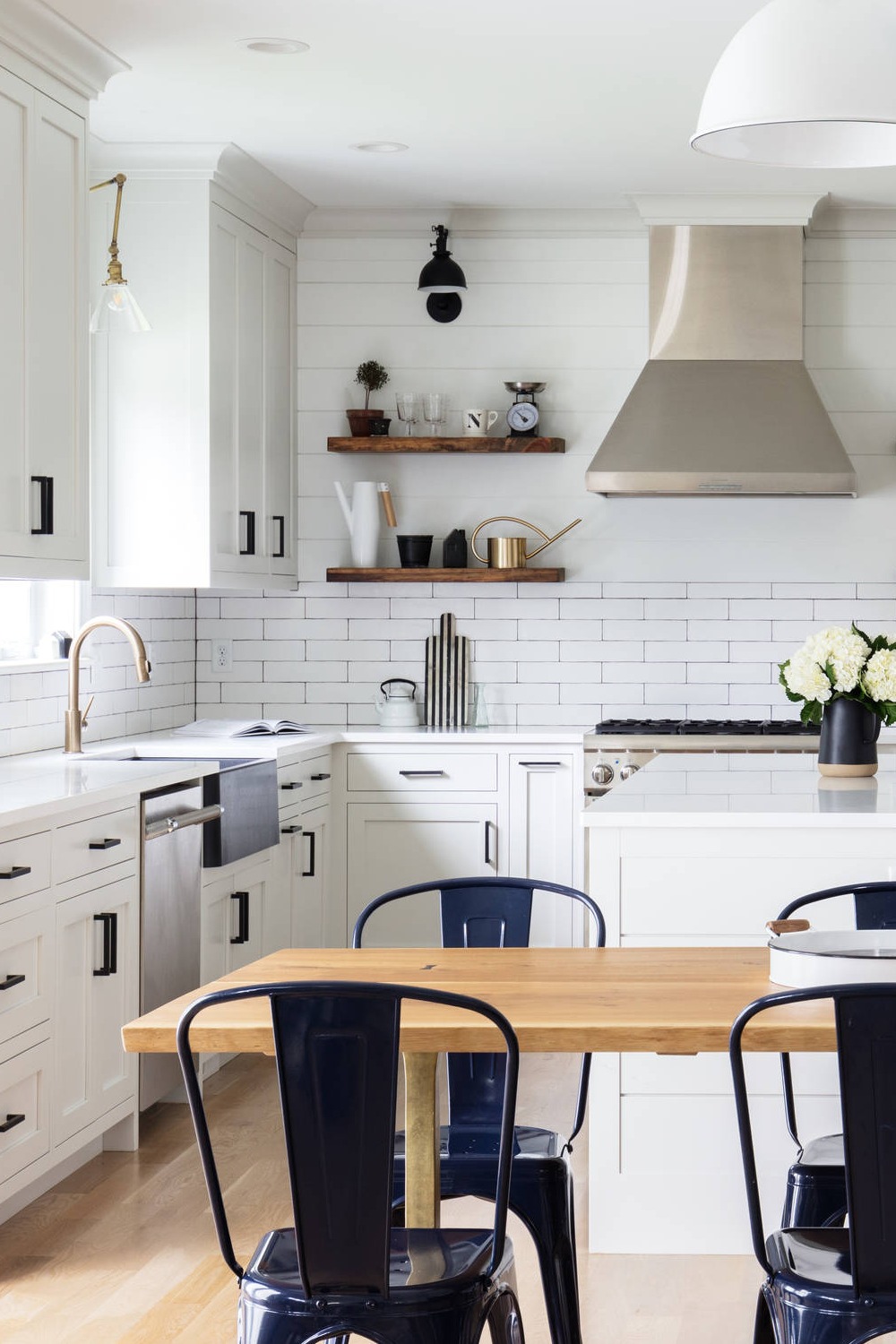 White Ceramic Backsplash Quartz Counters Shaker Cabinet Light Hardwood Flooring Farmhouse Sink