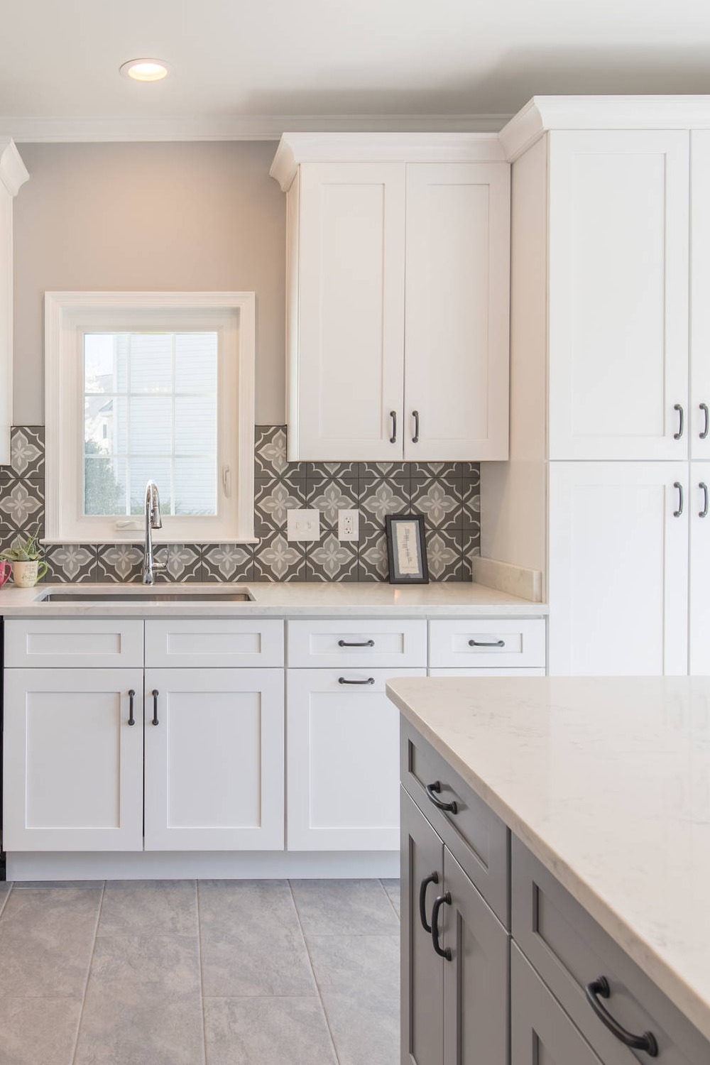 White Pantry Cabinets Multicolored Cement Backsplash Quartz Counters Grey Floor