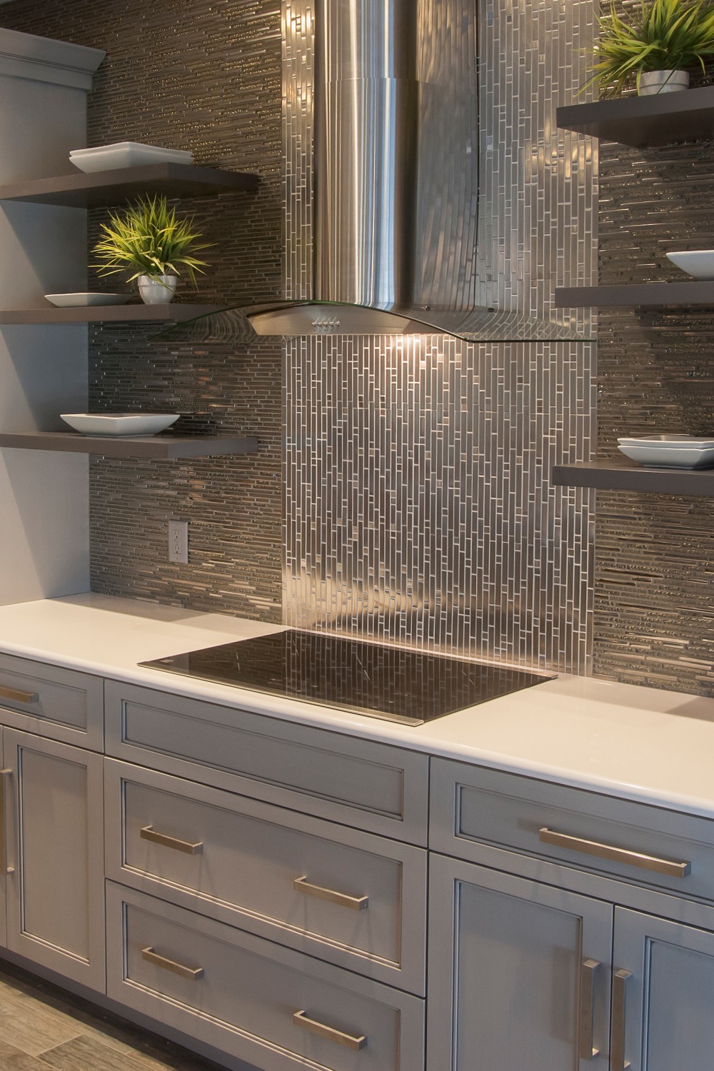 Grey Cabinetry Quartz Counters Metallic Backsplash Brown Ceramic Tile Flooring