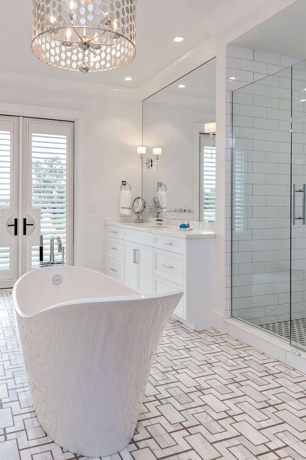 Free Standing Bathtub White Cabinetry Mosaic Flooring Marble Tops Hinged Shower Door