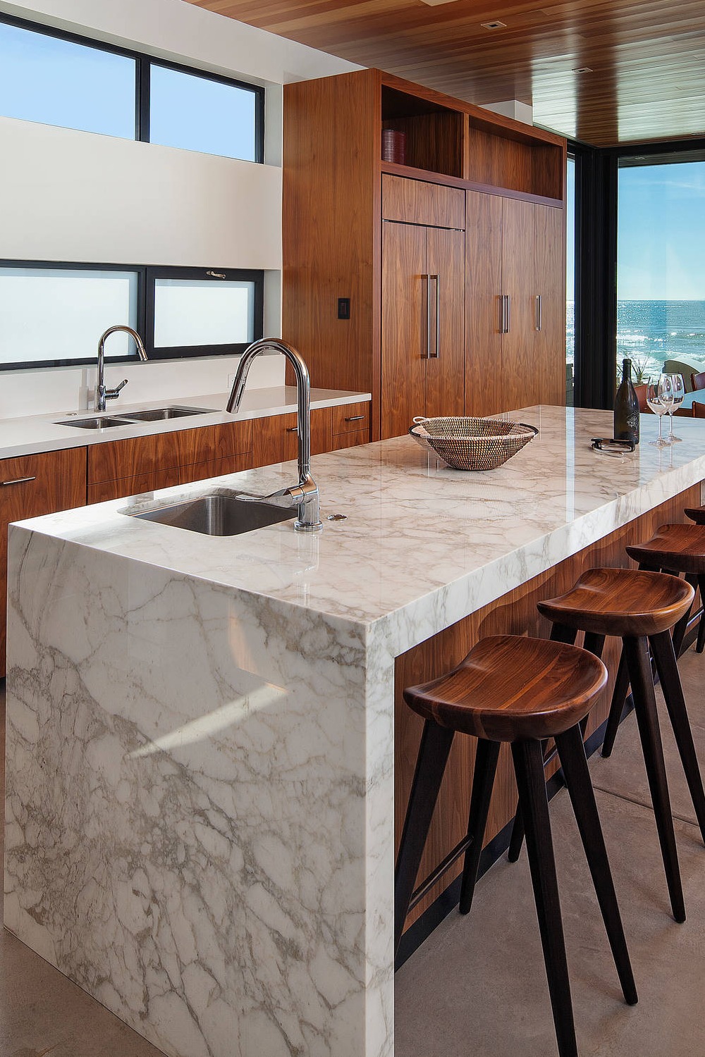 Large Format Concrete Floors Marble Counters Brown Cabinet