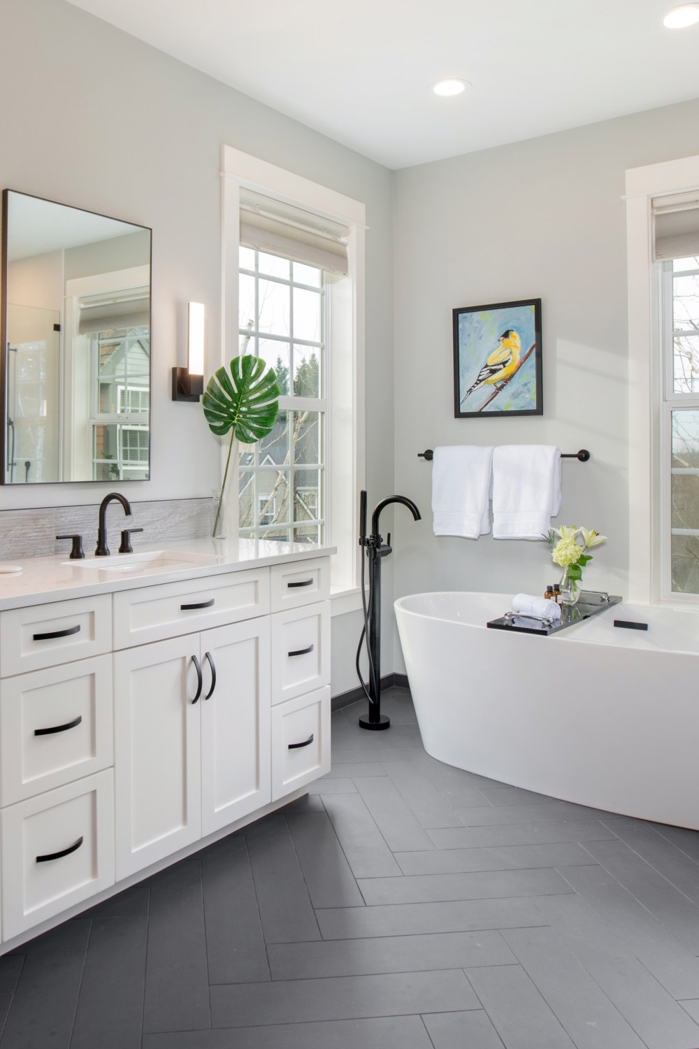 Shaker White Cabinetry Black Hardware Gray Ceramic Tile Freestanding Bathtub Quartz Counter Double Sink