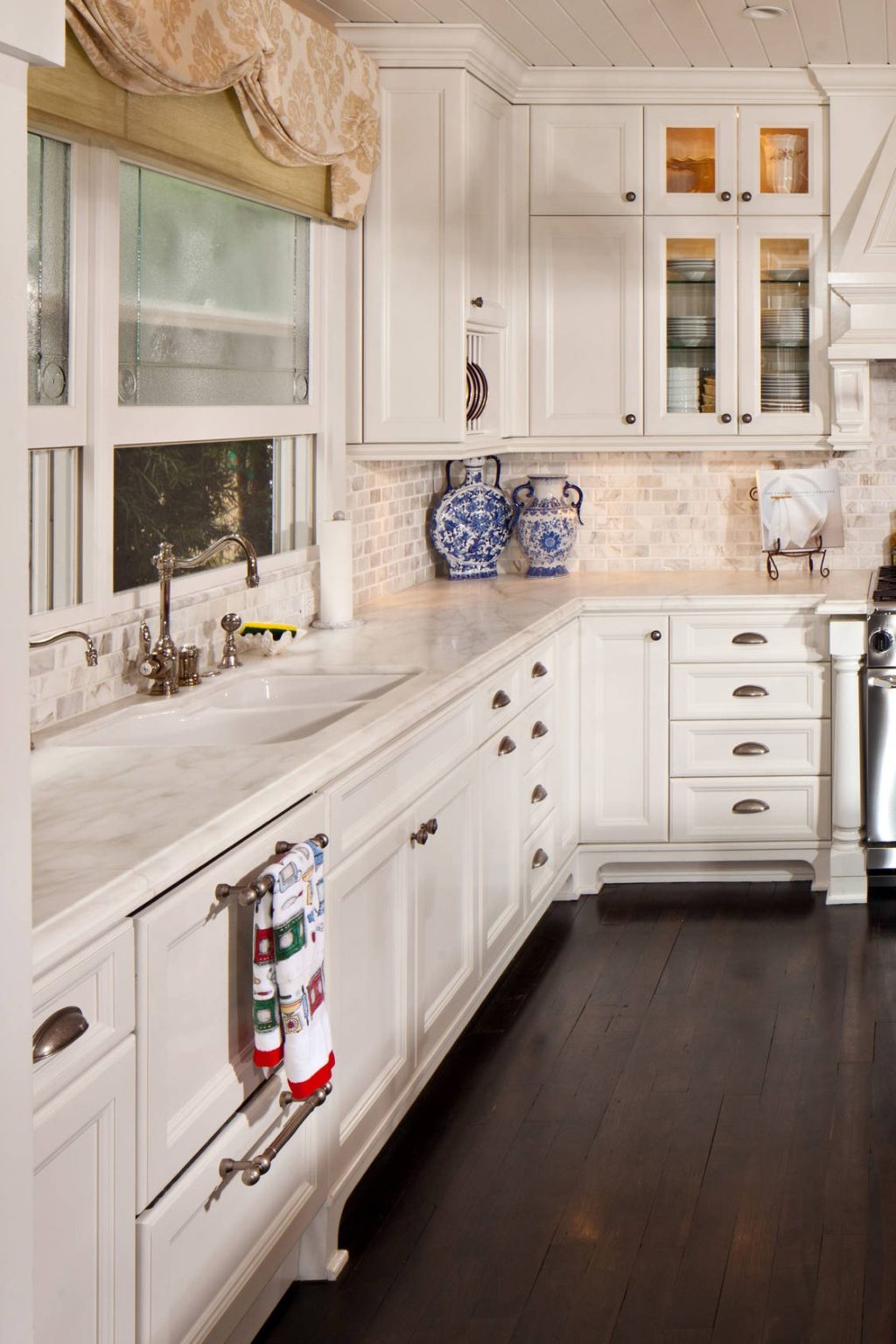 White kitchen with white cabinets and white backsplash