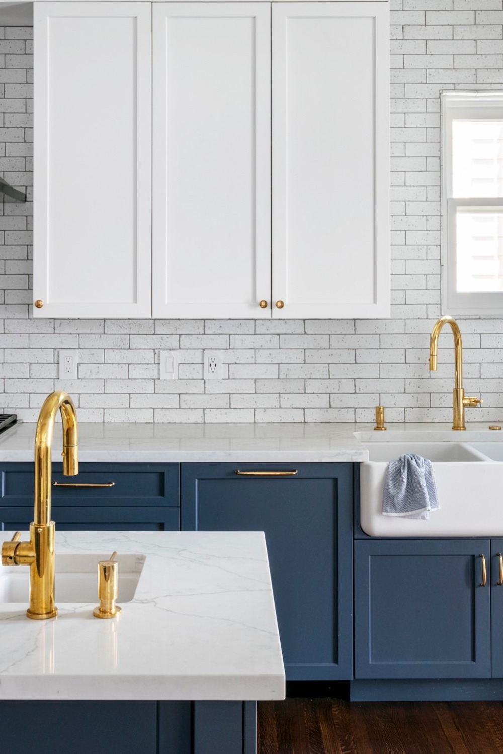 Blue And White Kitchen Features White upper Cabinets Blue Lower Cabinets Marble Countertops Farmhouse Sink Backsplash Navy Blue Cabinets Backsplash White Countertops