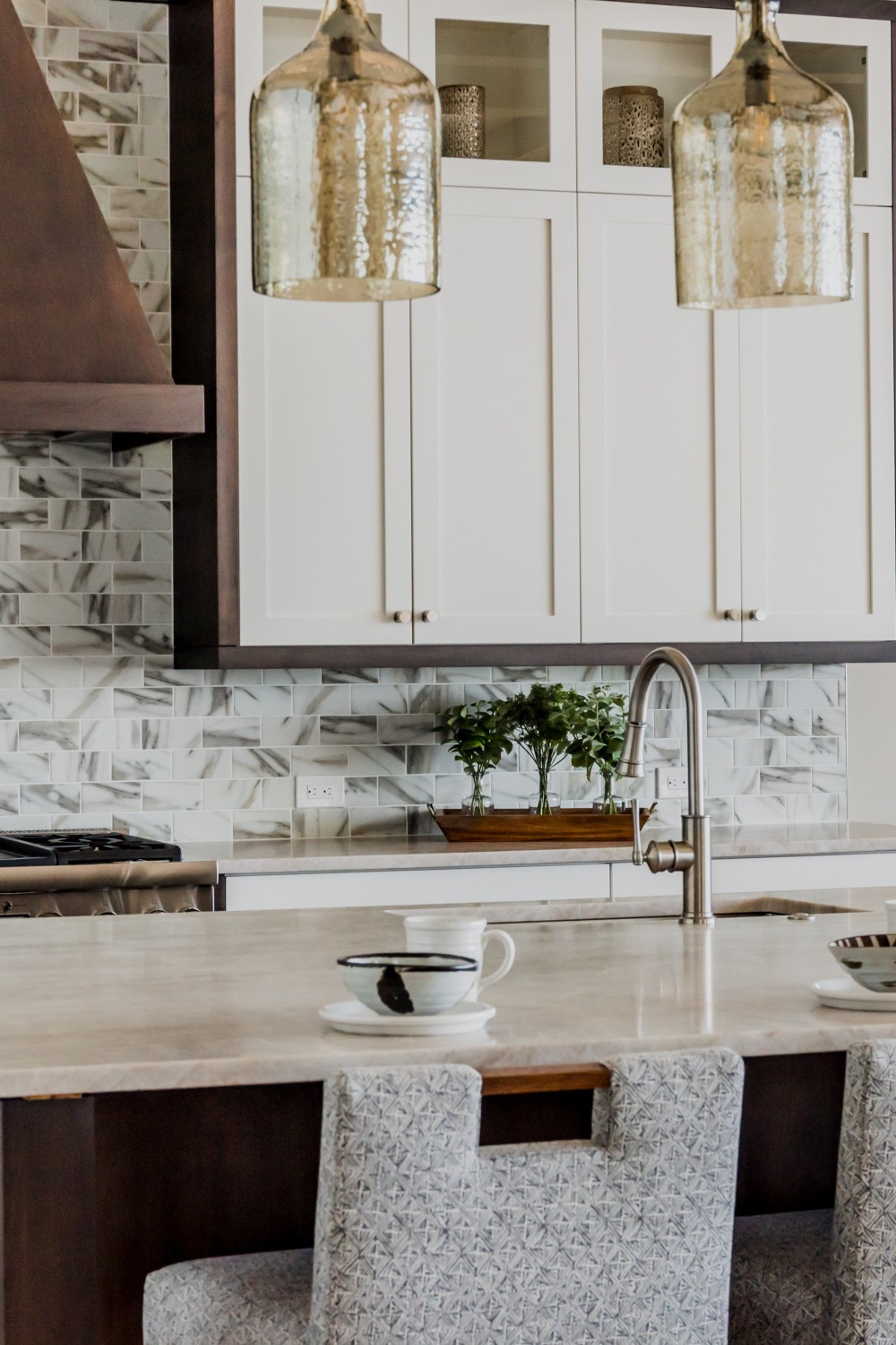 Kitchen Features White Cabinetry Gold Backsplashes Brass Hardware Granite Countertops Contrast