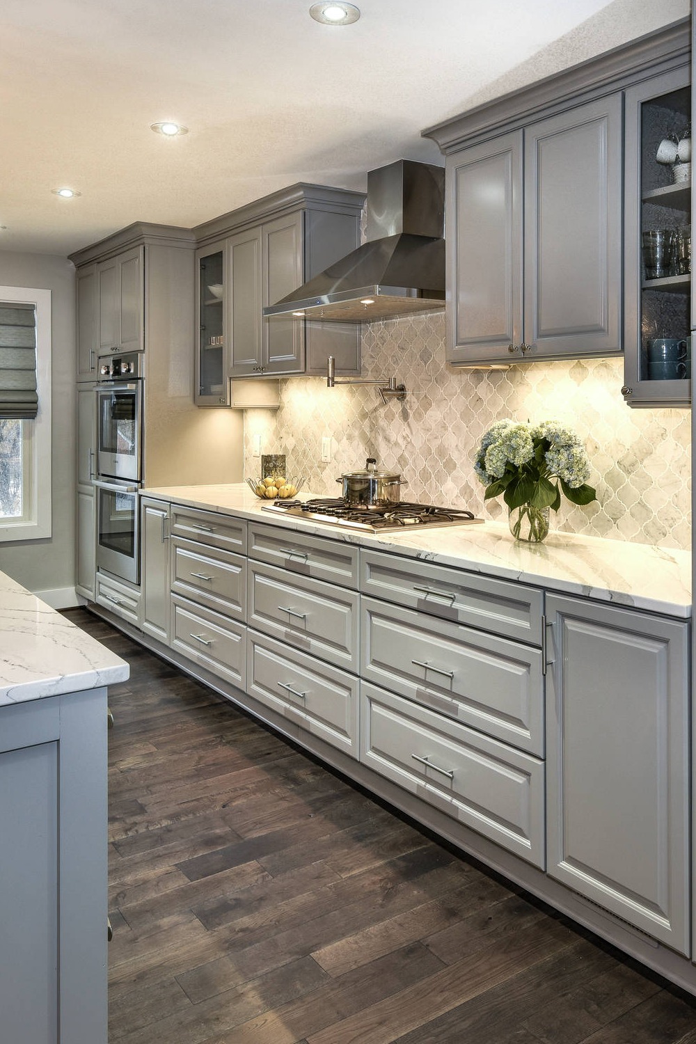 Transitional Kitchen Layout Recessed Panel Gray Island Cabinet Gray Colors White Backsplash Stainless Steel Appliances
