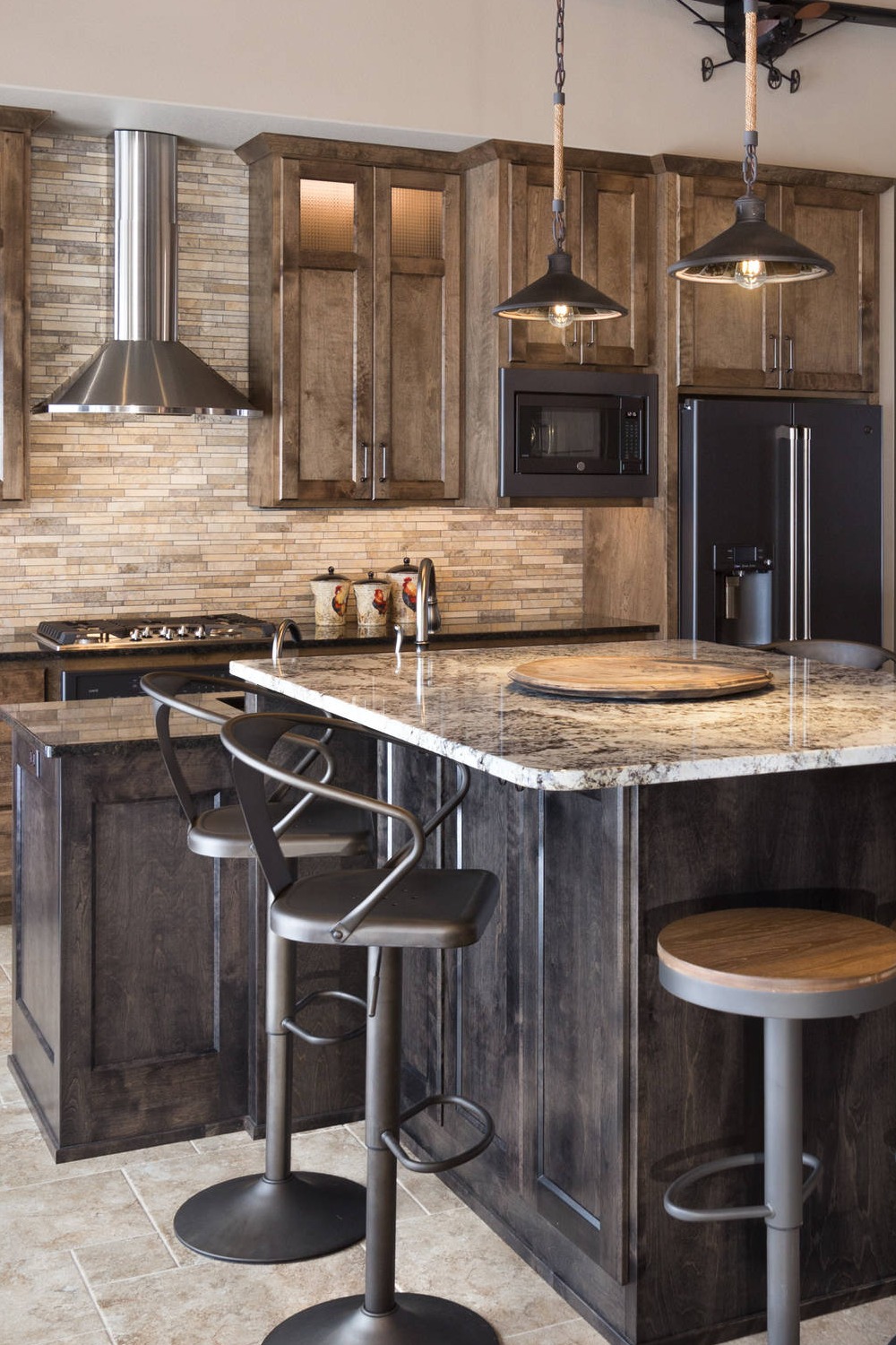 Stainless Steel Appliances Granite Countertops Rustic Style Gray Backsplash Wood Cabinetry Range Hood