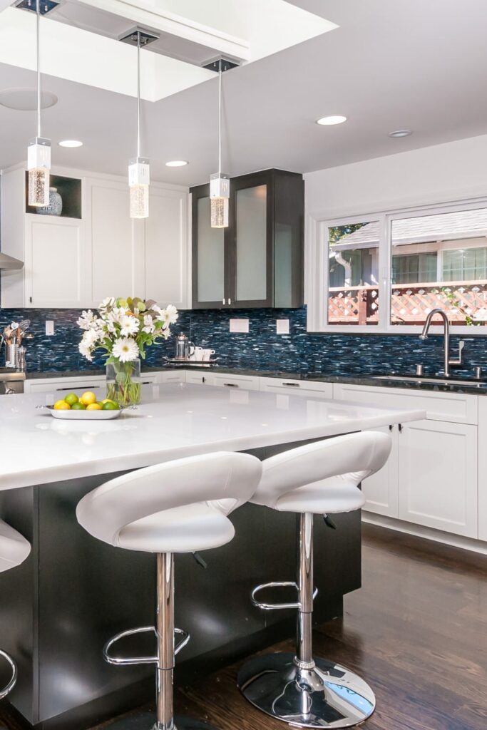 Elegant White Kitchen with Dark Blue Backsplash Design