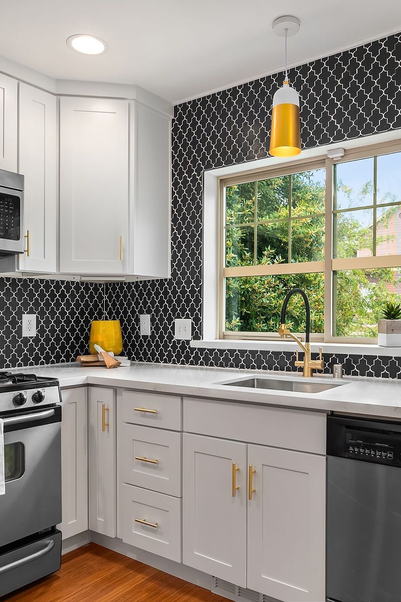 Stainless Steel Appliances Patterned Tile Backsplash Gray Backsplash Modern Backsplash White Kitchen Cabinets Natural Stone